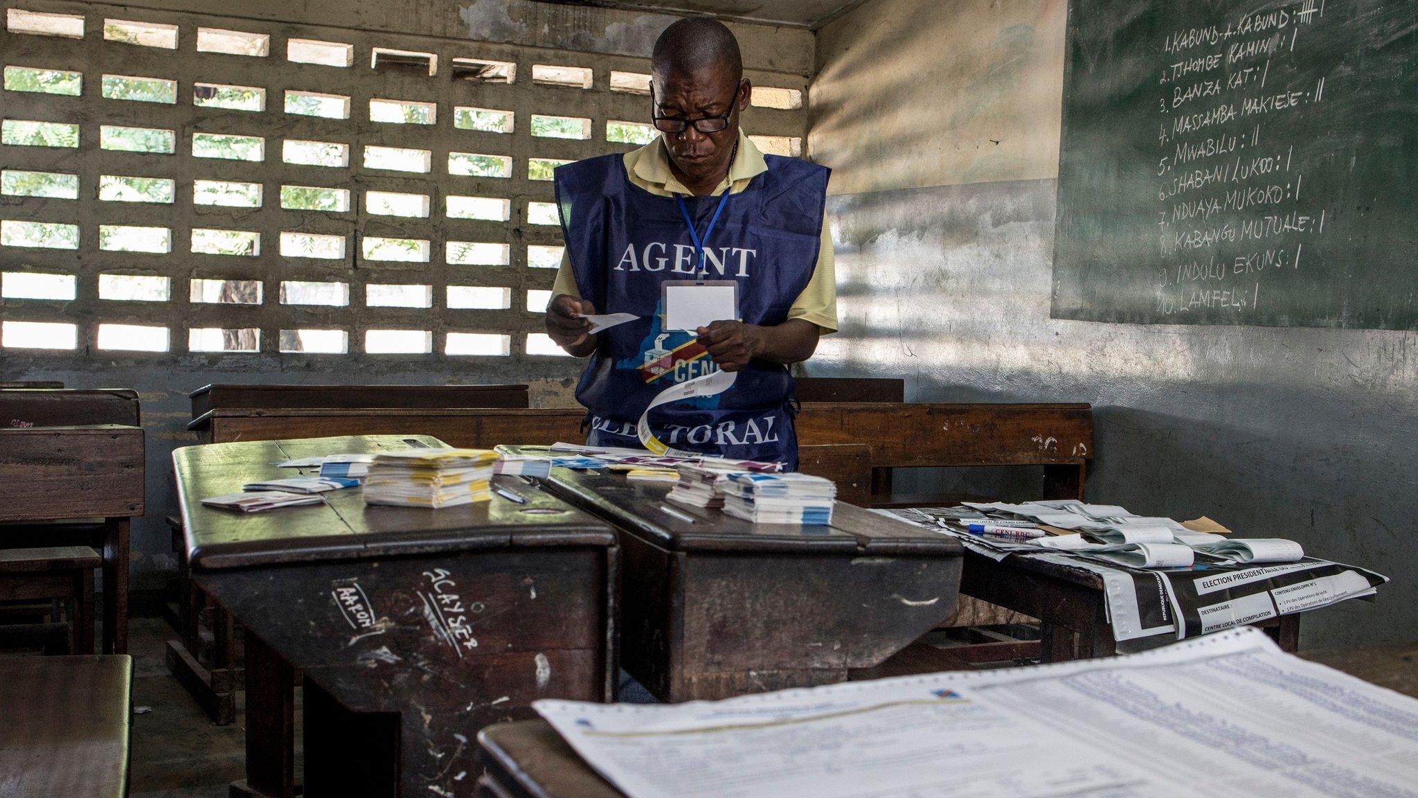 Electoral official arranges ballots at a polling station in Kinshasa on 31 December 2018