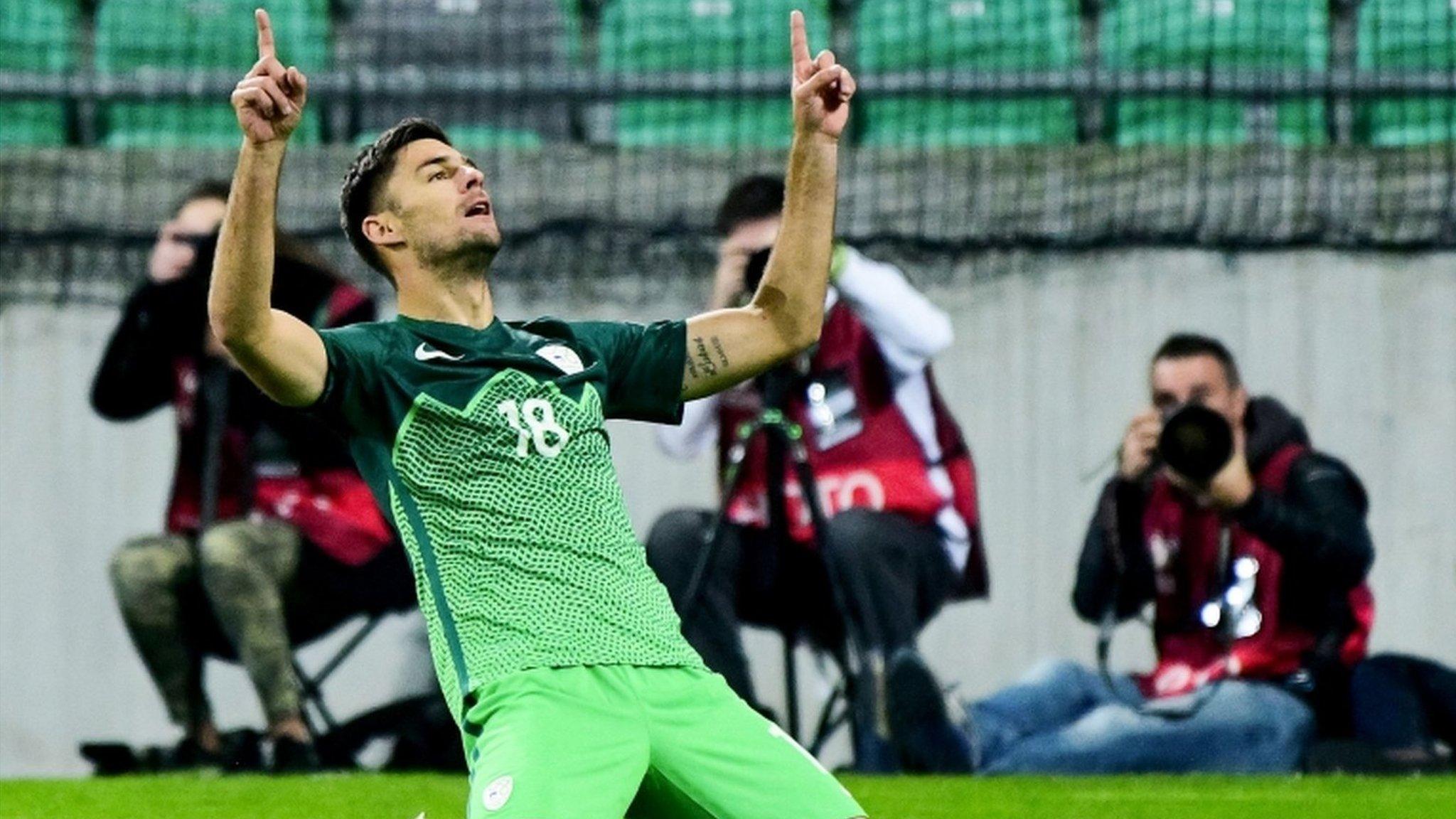 Slovenia's Rok Kronaveter celebrates scoring their winner