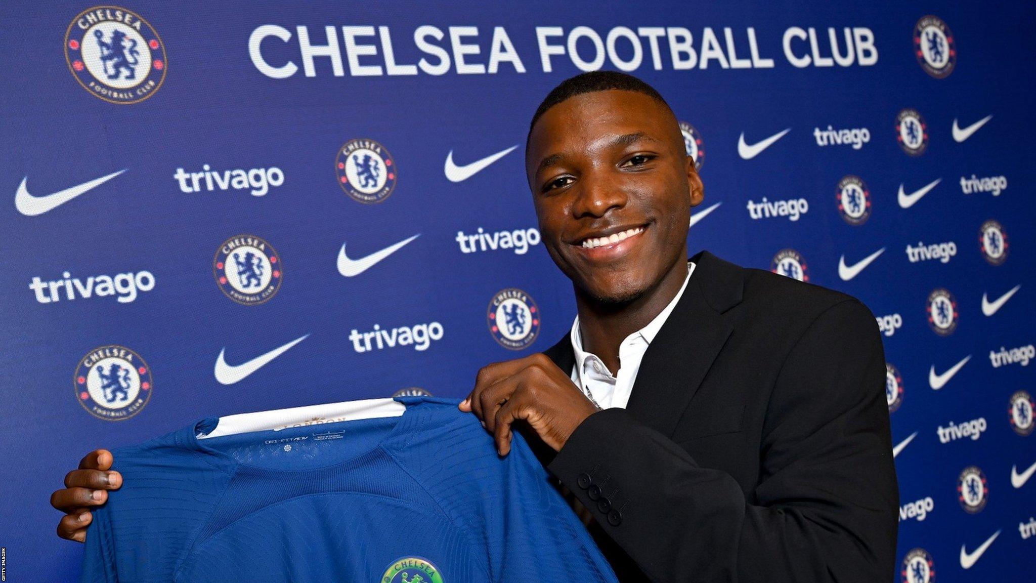 Moises Caicedo holds a Chelsea shirt after signing for the club