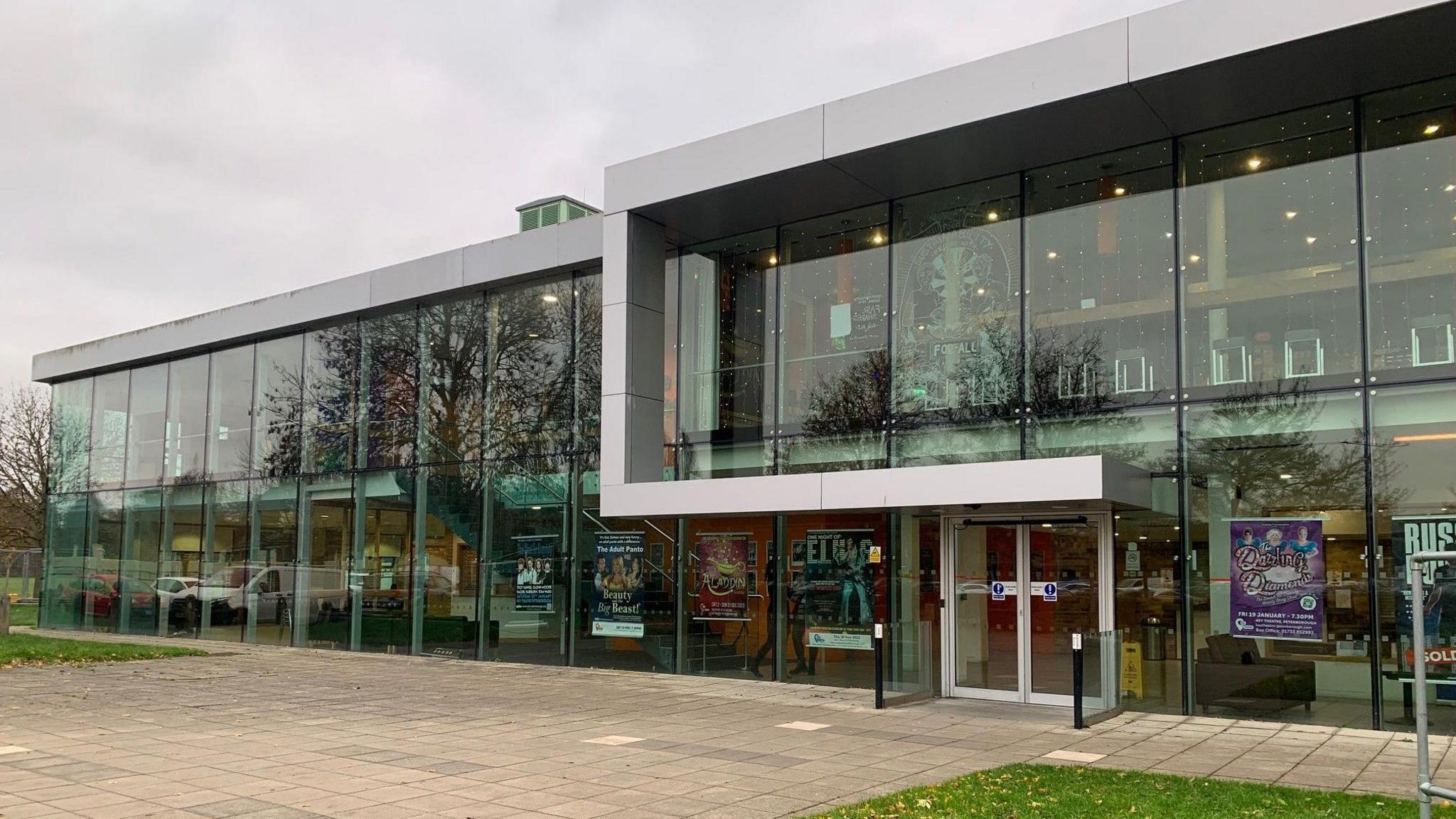 The Key Theatre - a glass-fronted building with paving and grass in front of it.