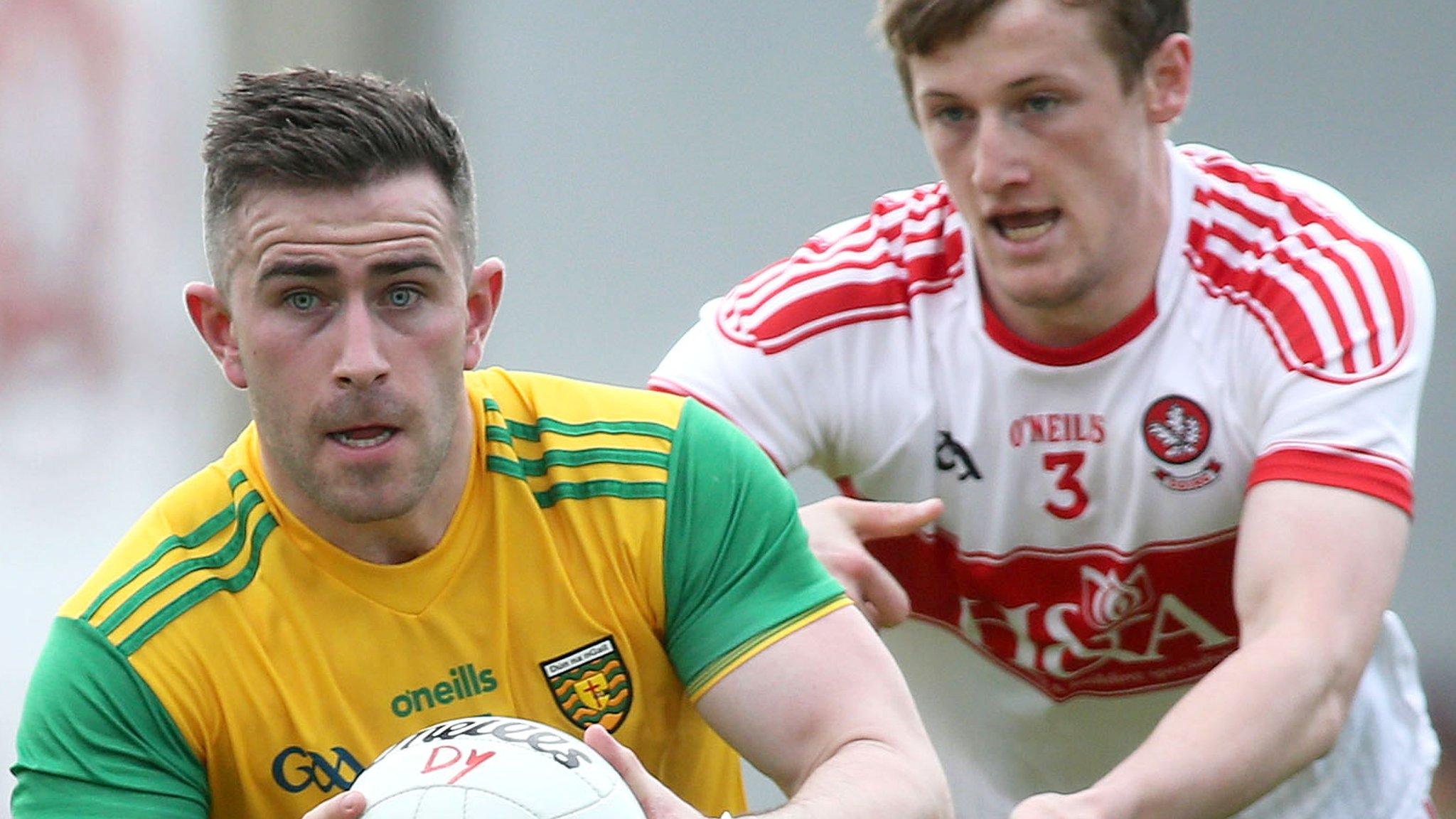 Donegal forward Patrick McBrearty is challenged by Derry's Brendan Rogers