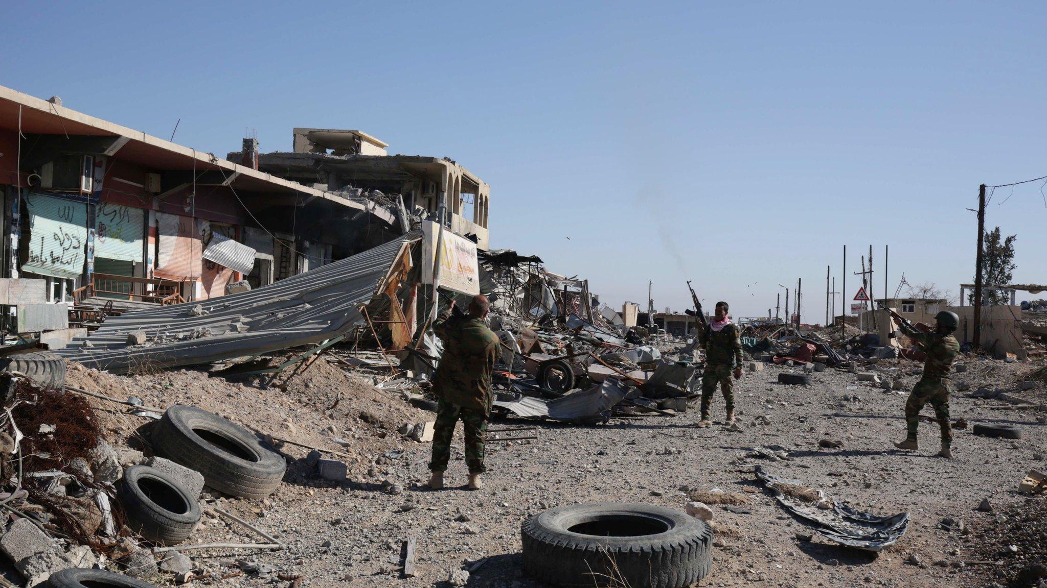 Kurdish Peshmerga fighters fire into the the air while celebrating the retaking of of Sinjar, northern Iraq, Friday 13 Nov 2015.