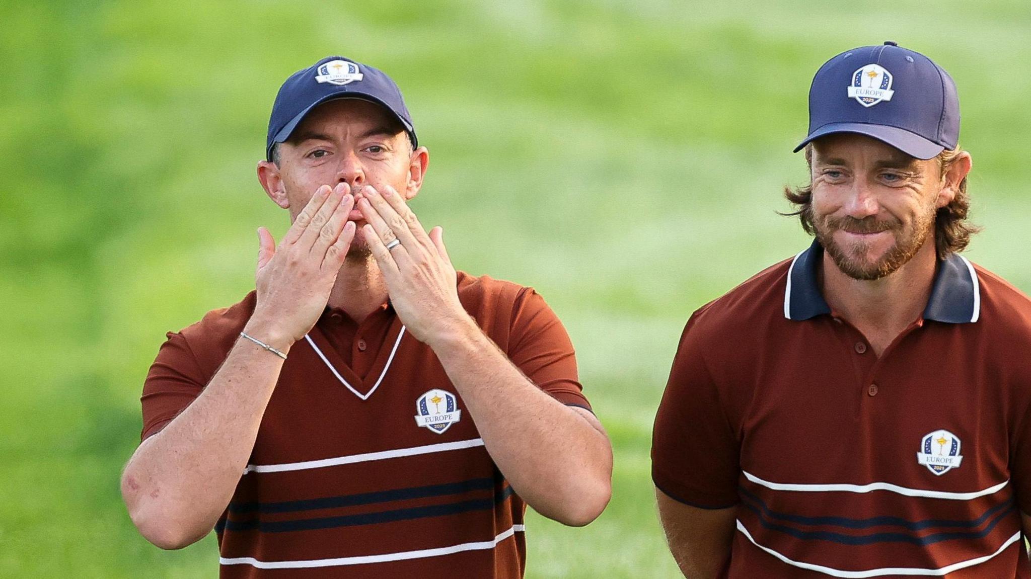Rory McIlroy cups his ear to the Ryder Cup crowd