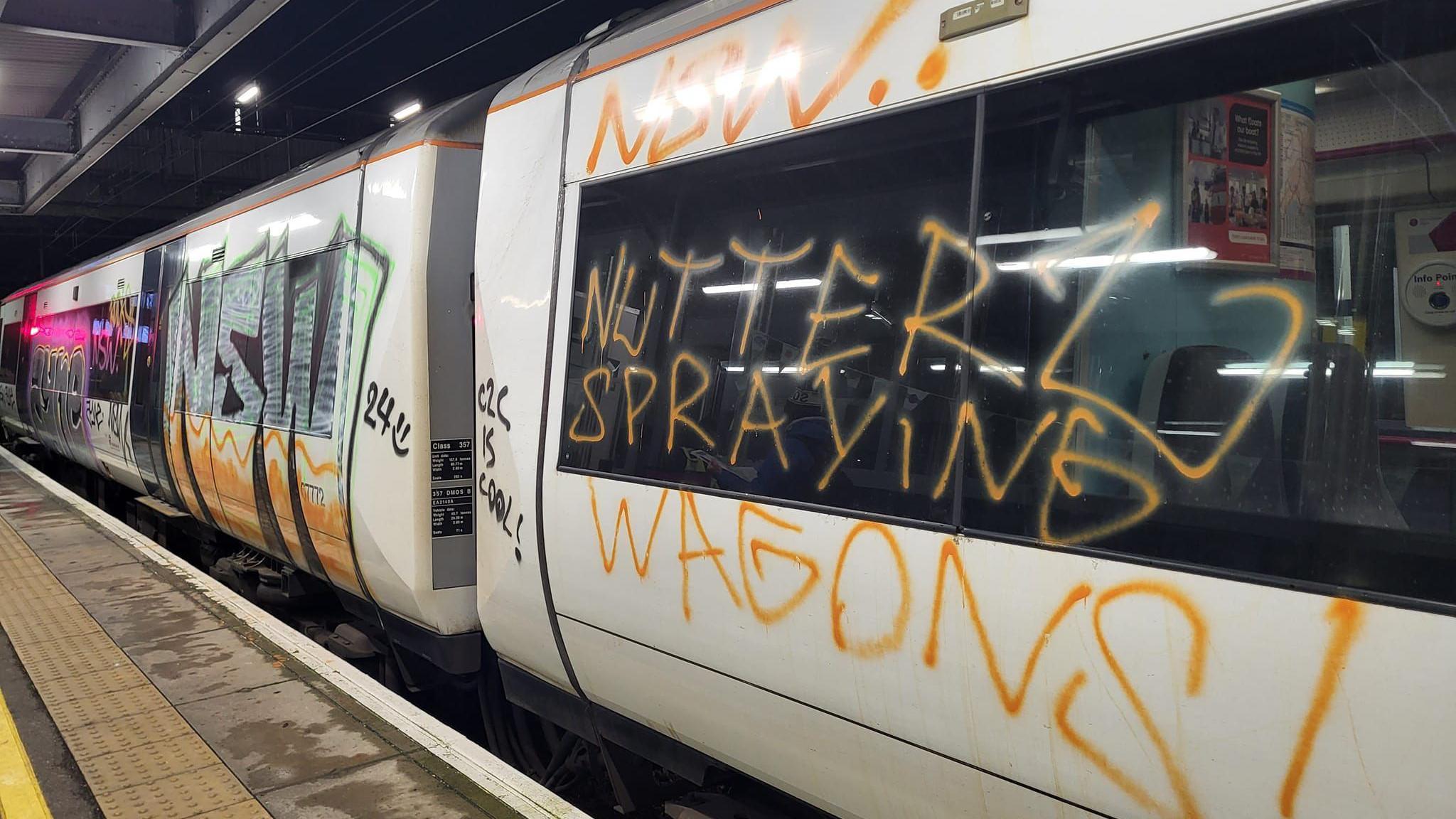 A train carriage covered in graffiti at Laindon railway station