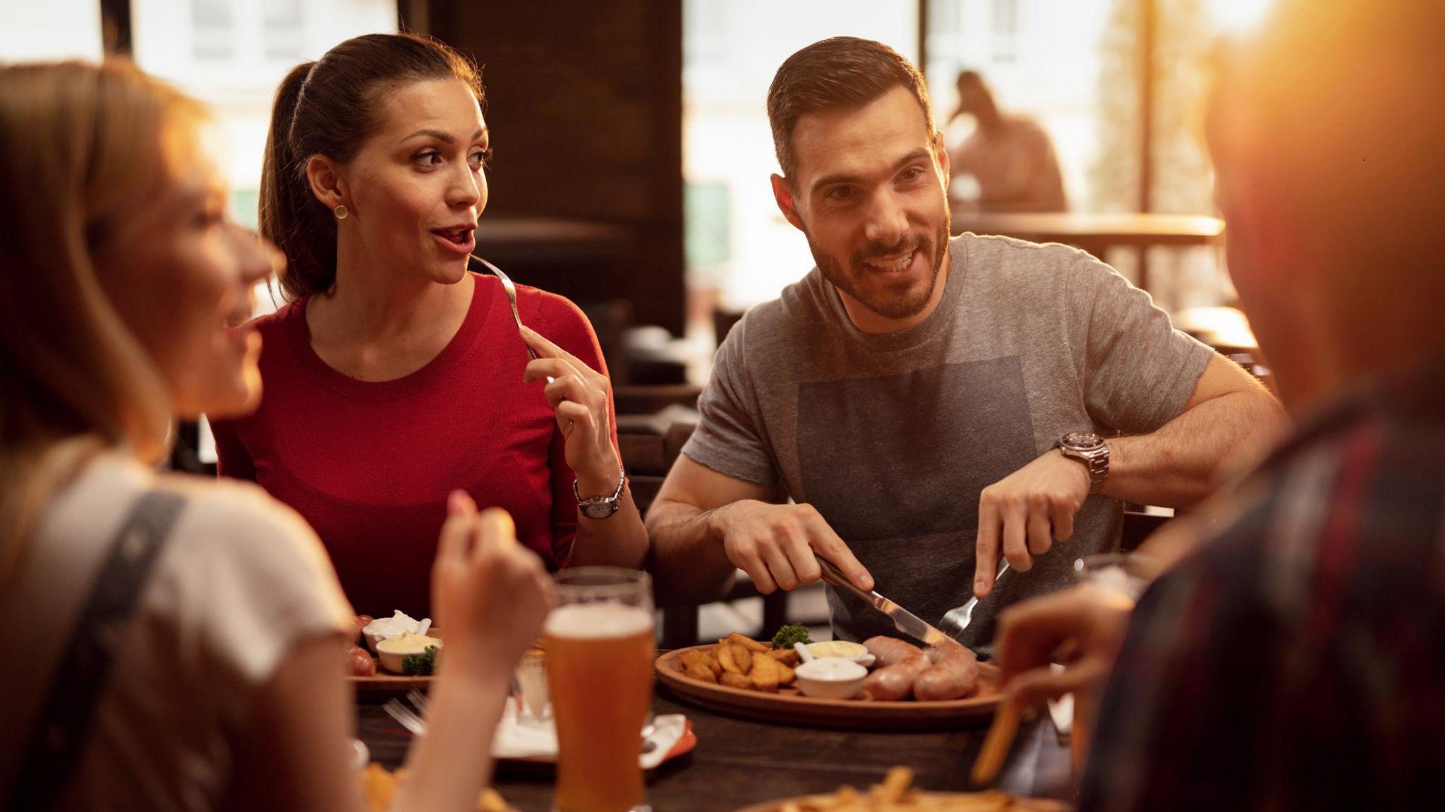 Group of happy friends having a lunch in a tavern.