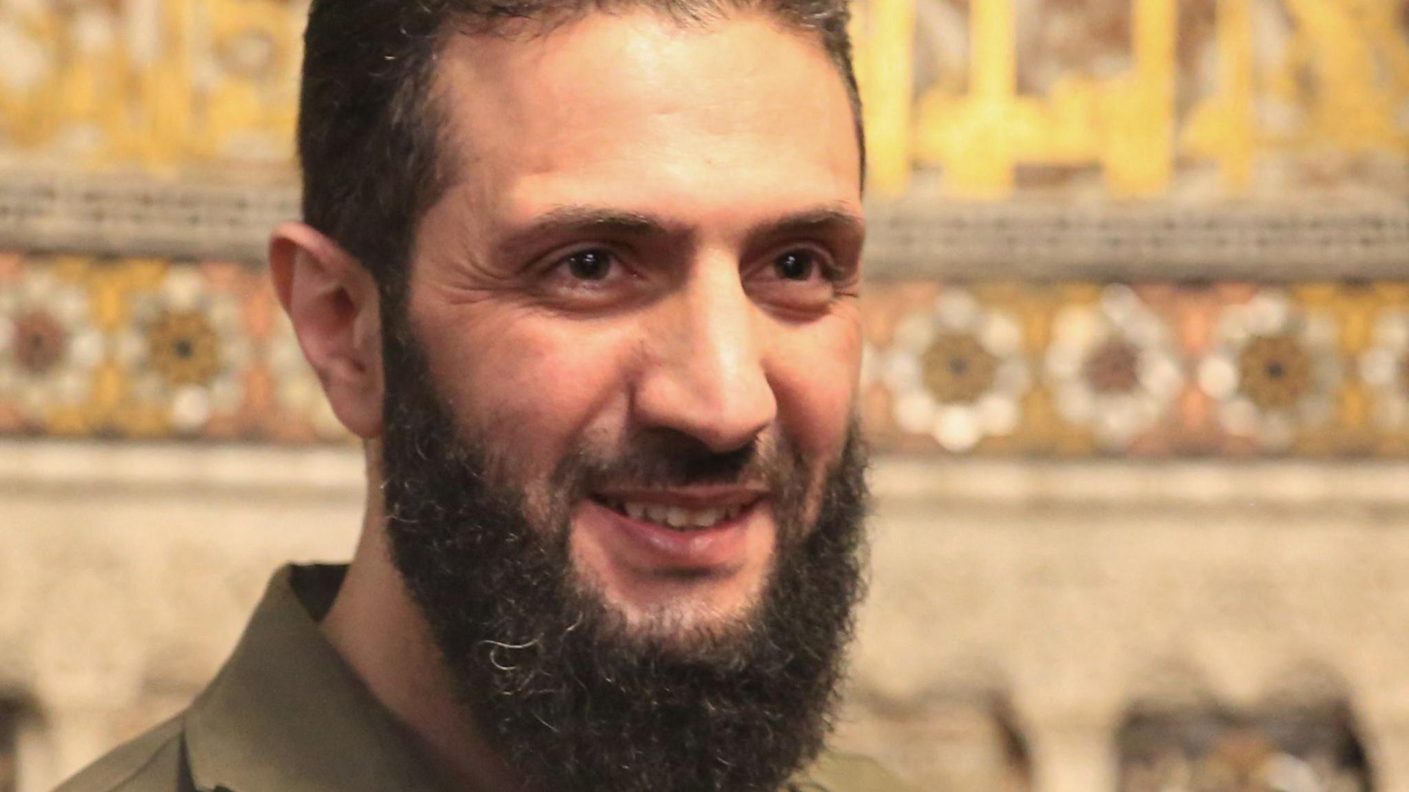 Ahmed al-Sharaa, also known as Abu Mohammed al-Jolani, smiles during a visit to the Umayyad Mosque in Damascus, Syria (8 December 2024)