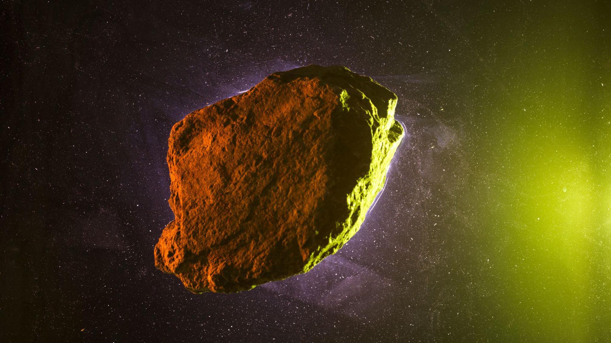 A computer generated image of an asteroid, a giant rock in space with a green haze around the image