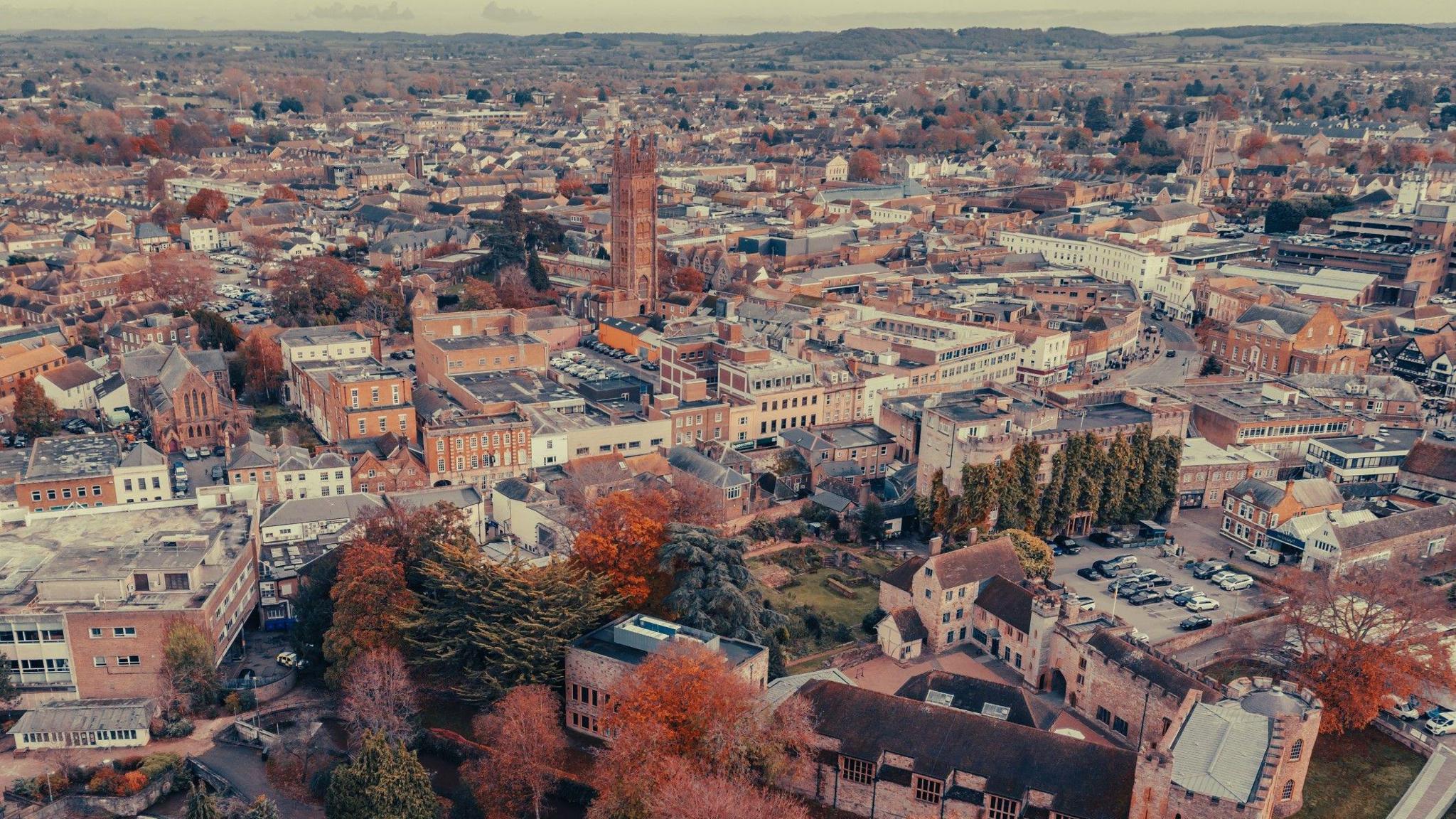 Aerial view of Taunton. The trees are autumnal and St Mary Magdalene Church's tower can be seen.