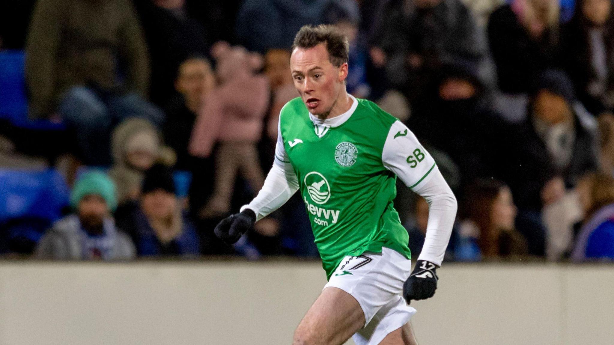 Harry McKirdy running with the ball during a game for Hibernian