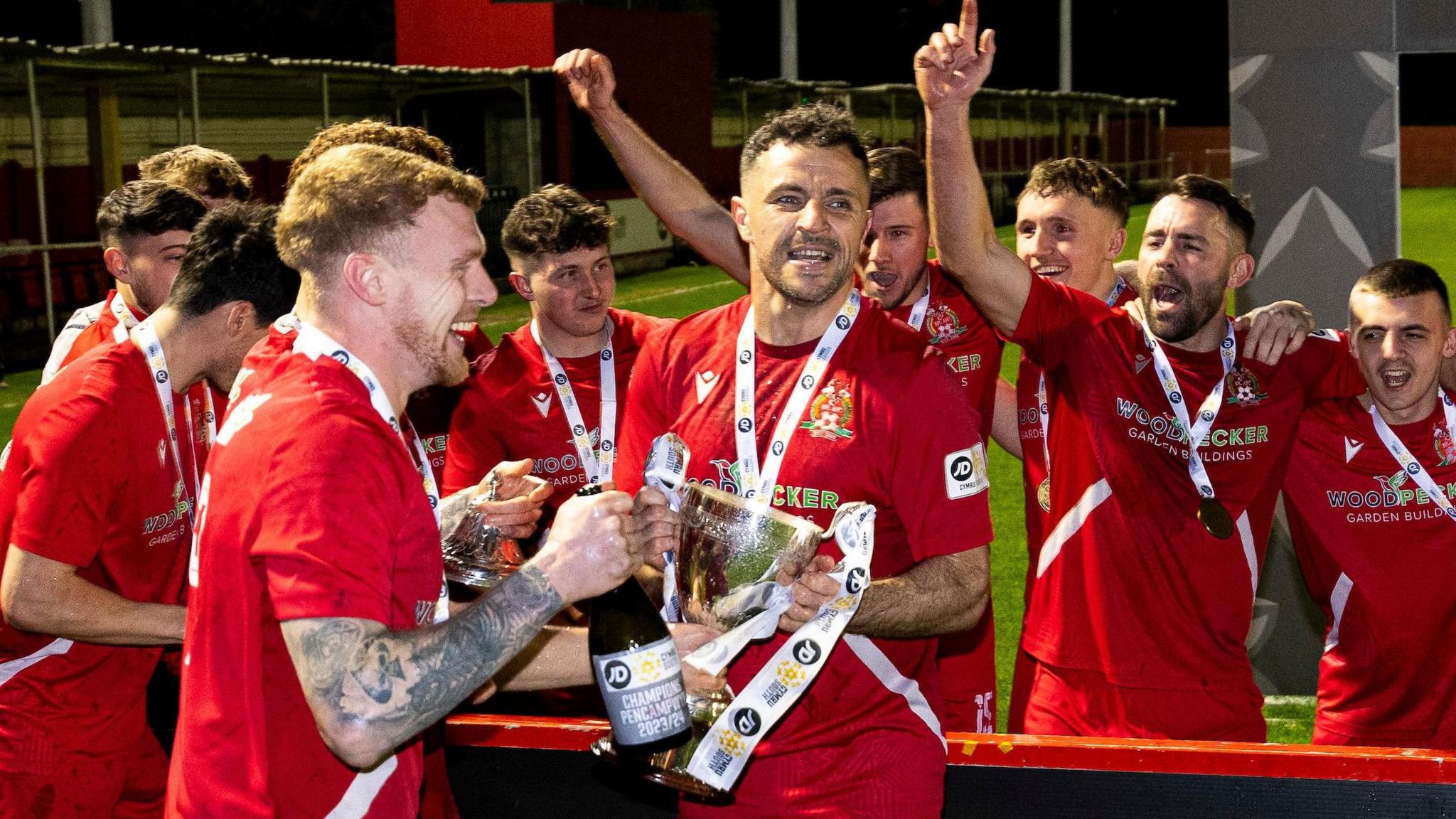 Briton Ferry Llansawel players celebrating winning the 2023-24 Cymru South title