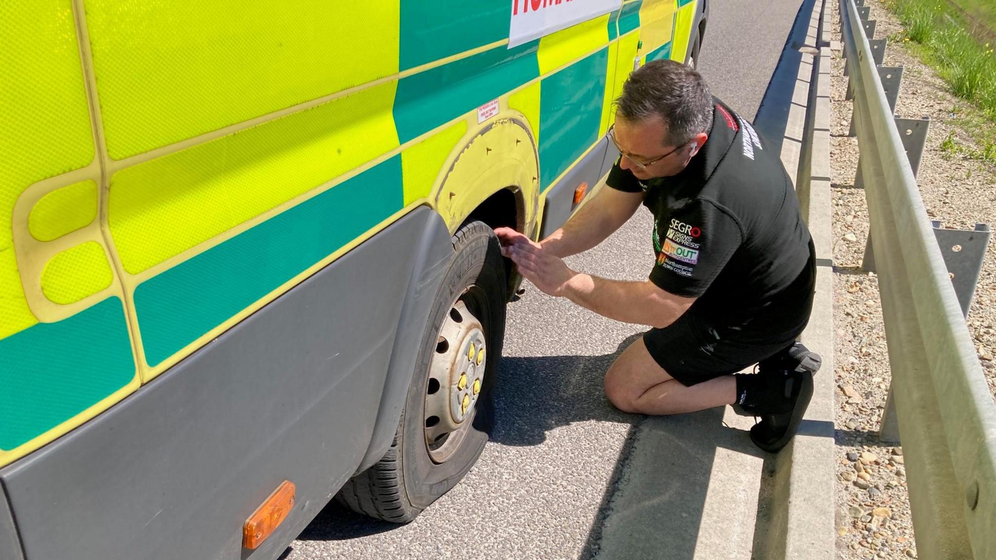 The group's interpreter examines a puncture on ambulance