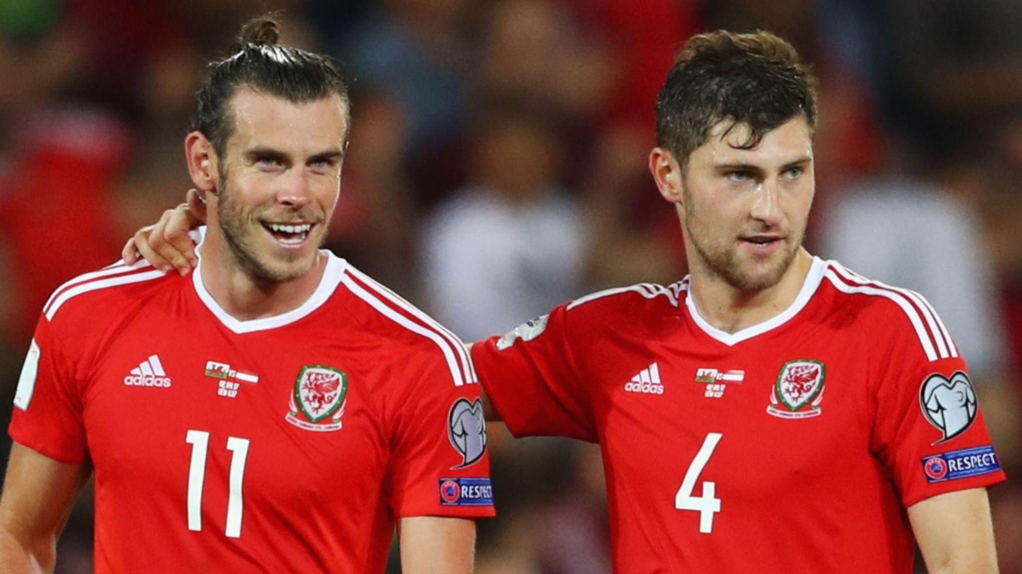 Ben Davies (right) has an arm around a smiling Gareth Bale during a Wales game