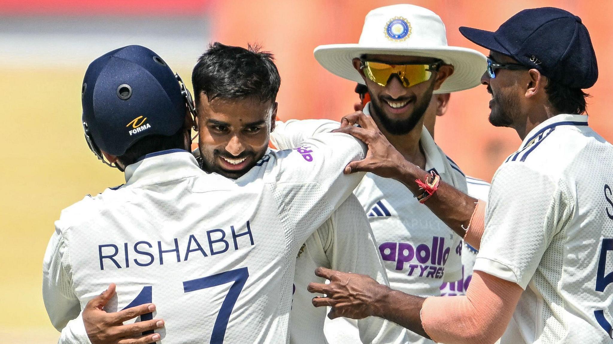 India's Manav Suthar is congratulated by team-mates