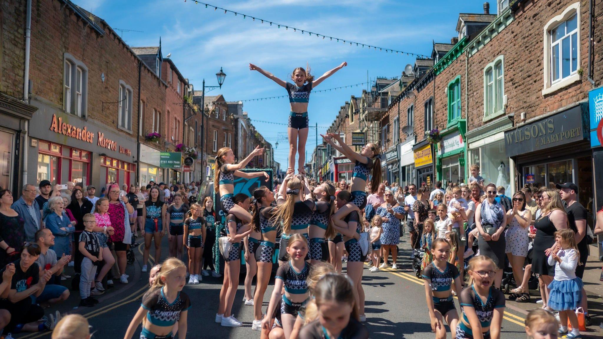 Cheerleaders at the parade for Maryport Carnival on Senhouse Street