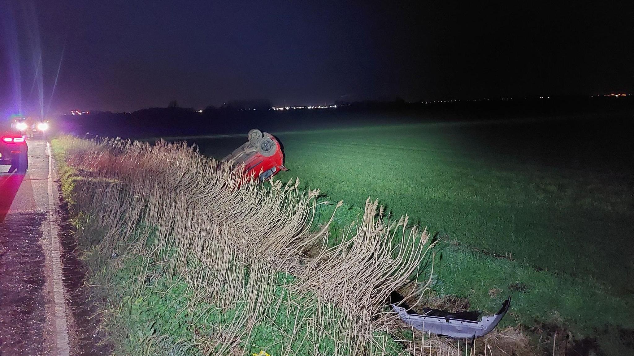 Red car in a ditch 