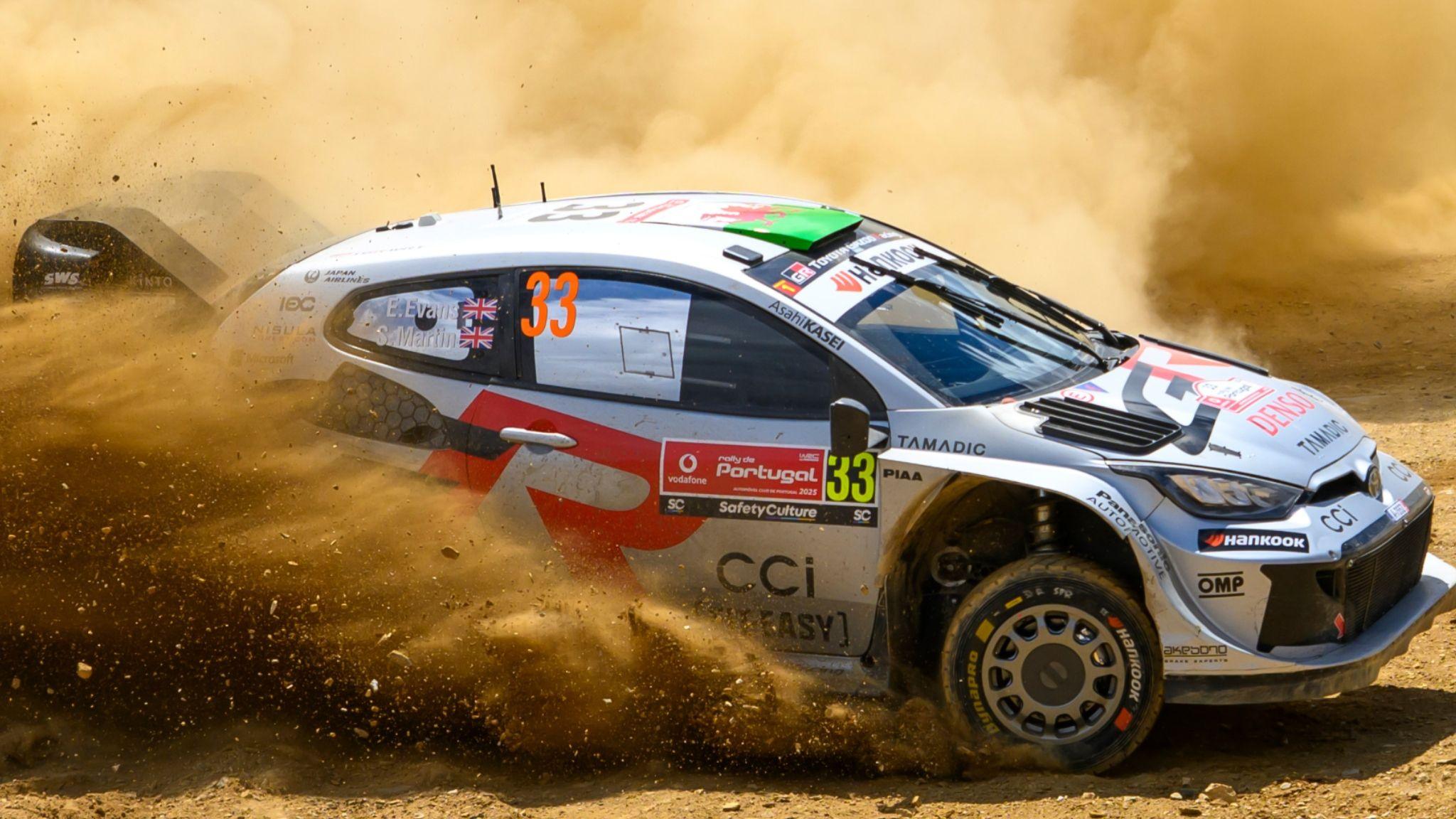 The Toyota Yaris of Elfyn Evans sprays up dust on the gravel surface of the Rally de Portugal