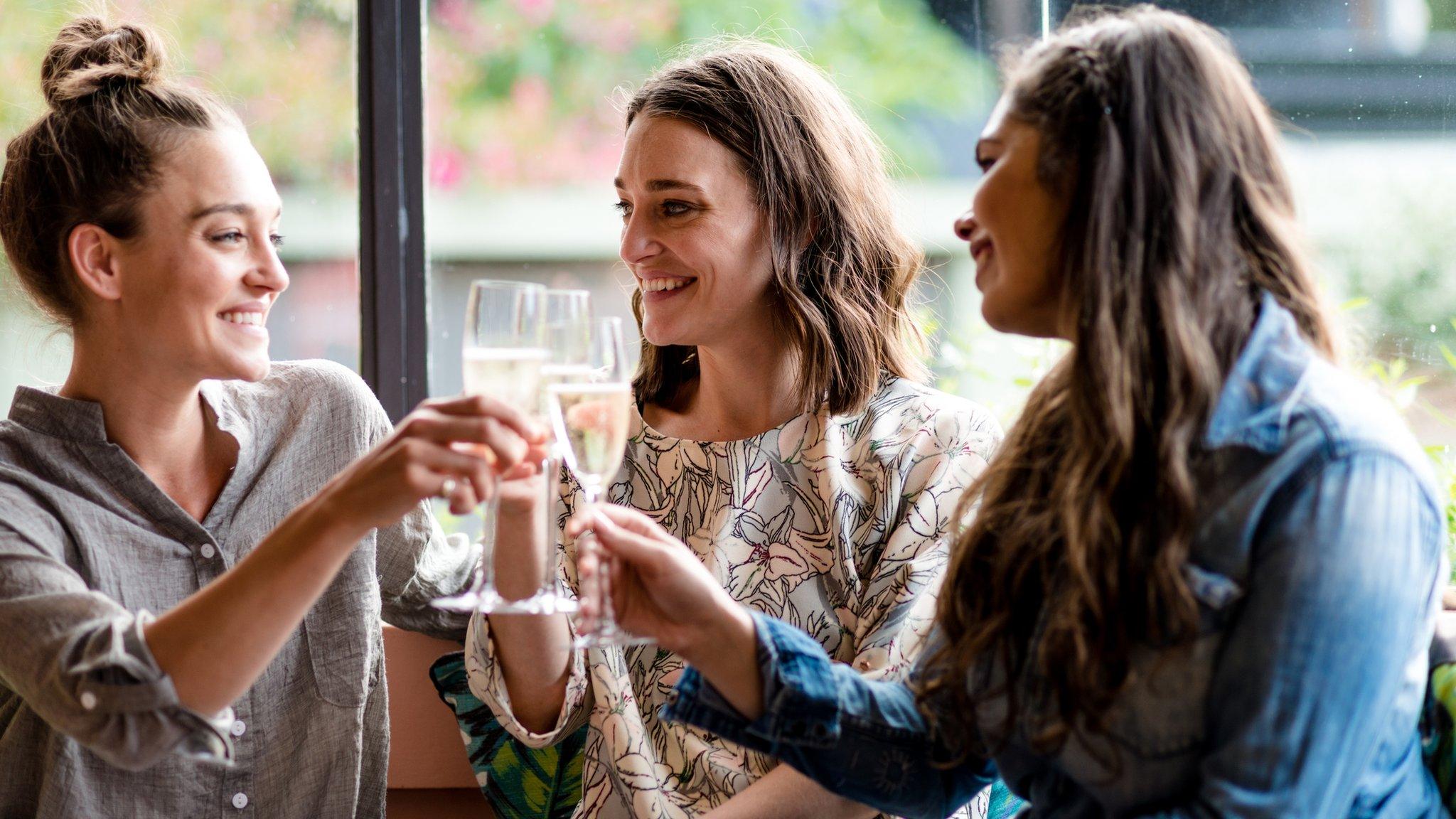 Three women drinking alcohol