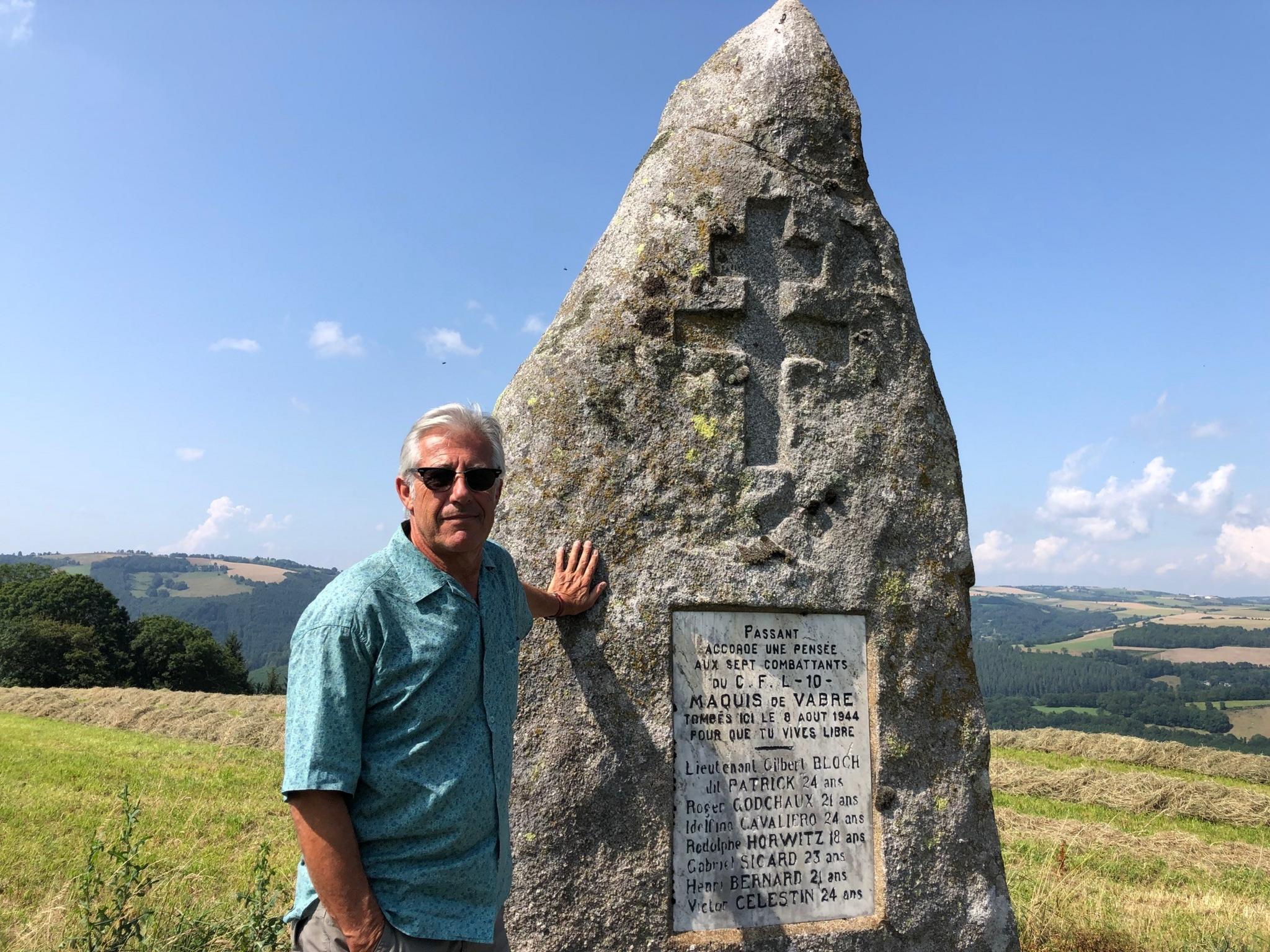 Prof Cals standing next to a memorial to fallen partisans