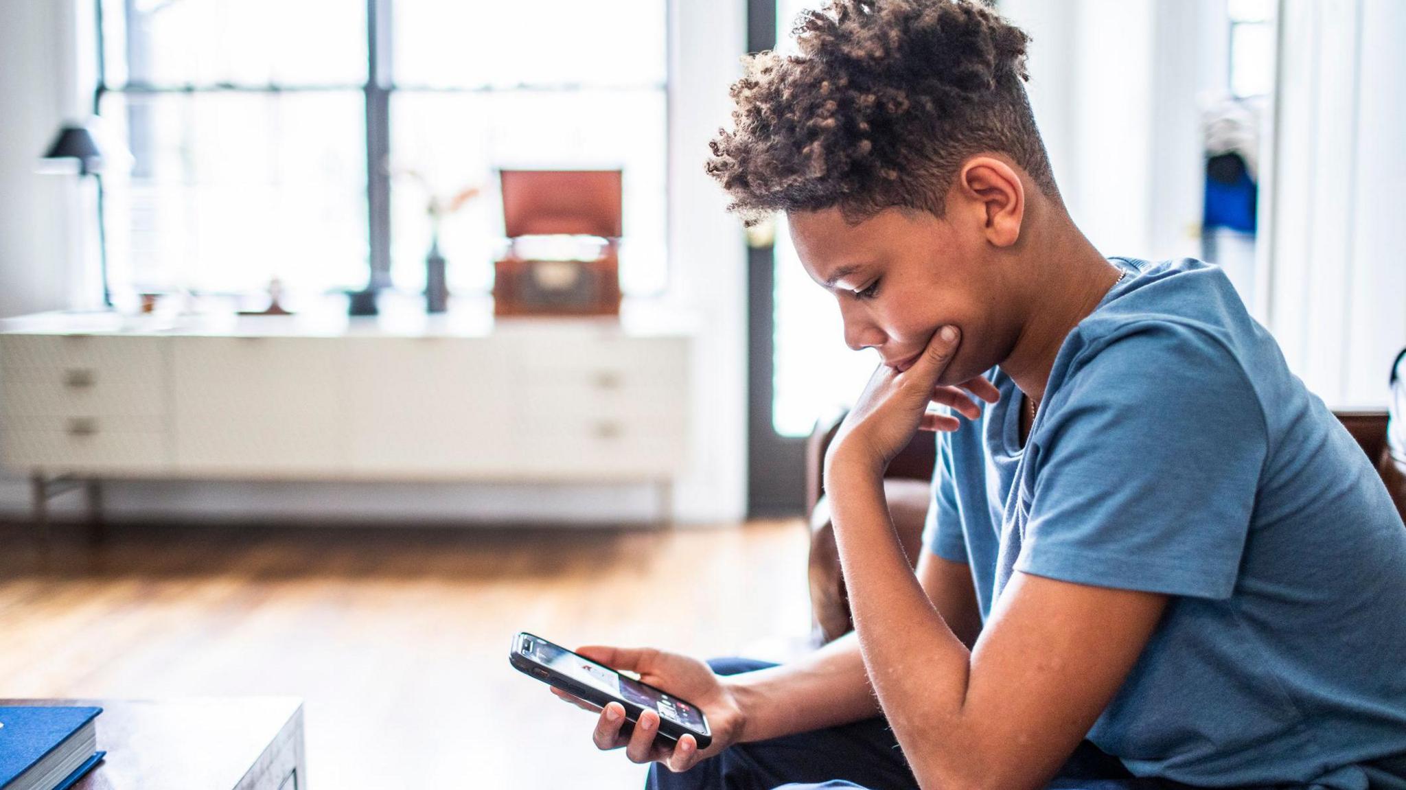 Young boy using a phone