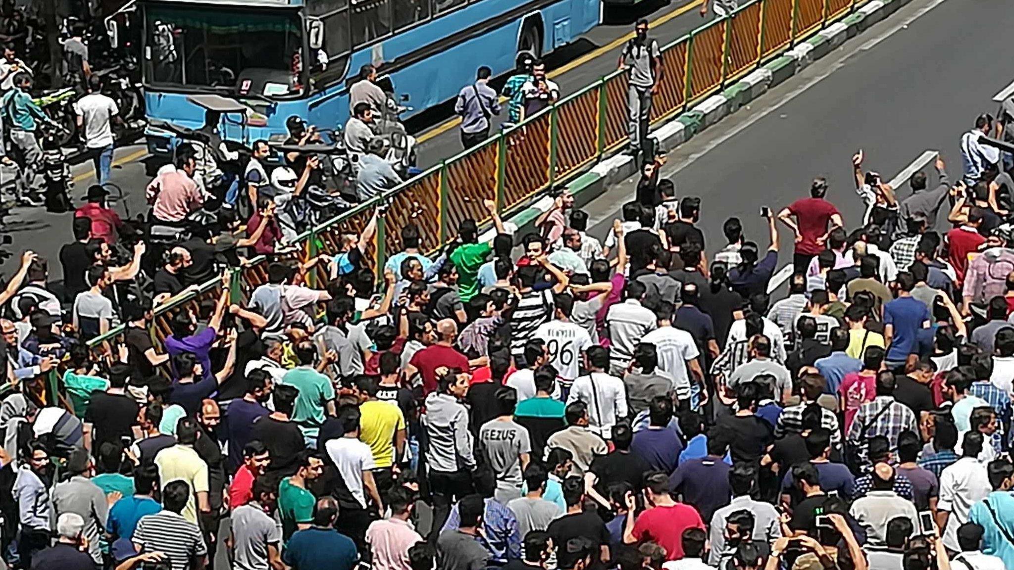 Iranian protesters gather outside mobile phone shop in Tehran on 25 June 2018