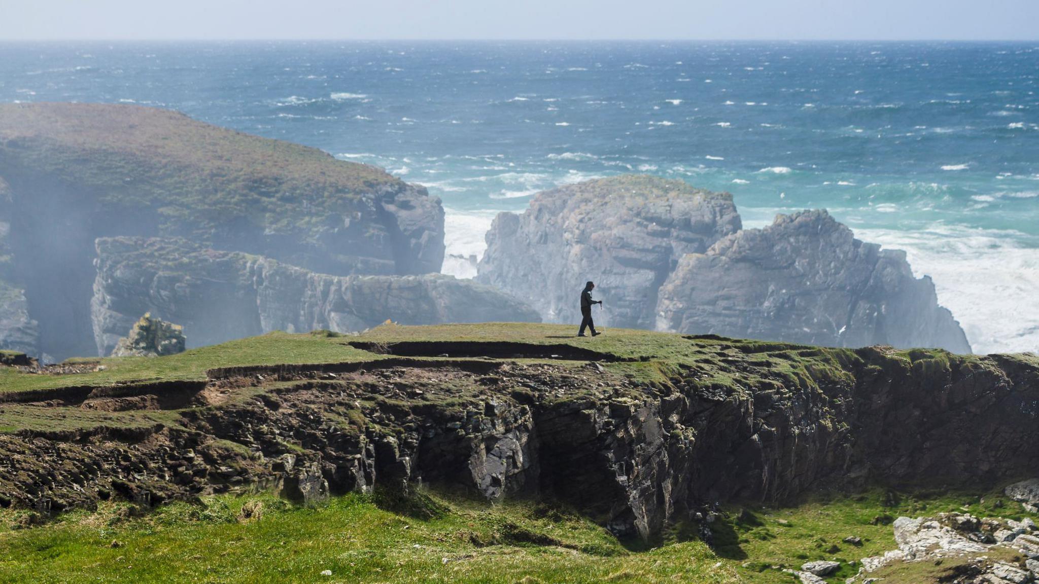 A person walking at the Butt of Lewis in Lewis, Western Isles