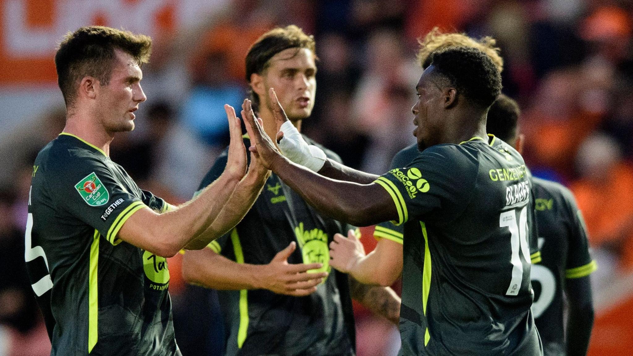 Tanto Olaofe of Lincoln City (R) celebrates scoring the opening goal at Blackpool with team-mate Josh Honohan