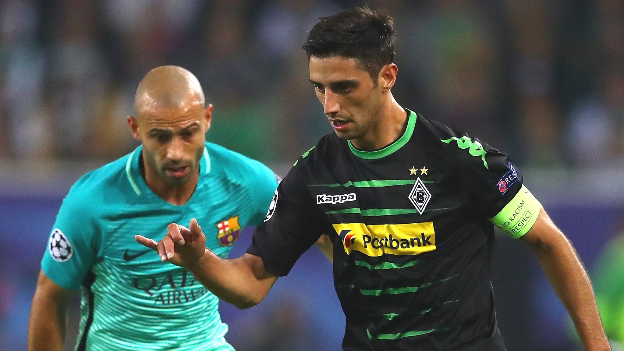 Gladbach captain Lars Stindl shields the ball from Barca's Javier Mascherano