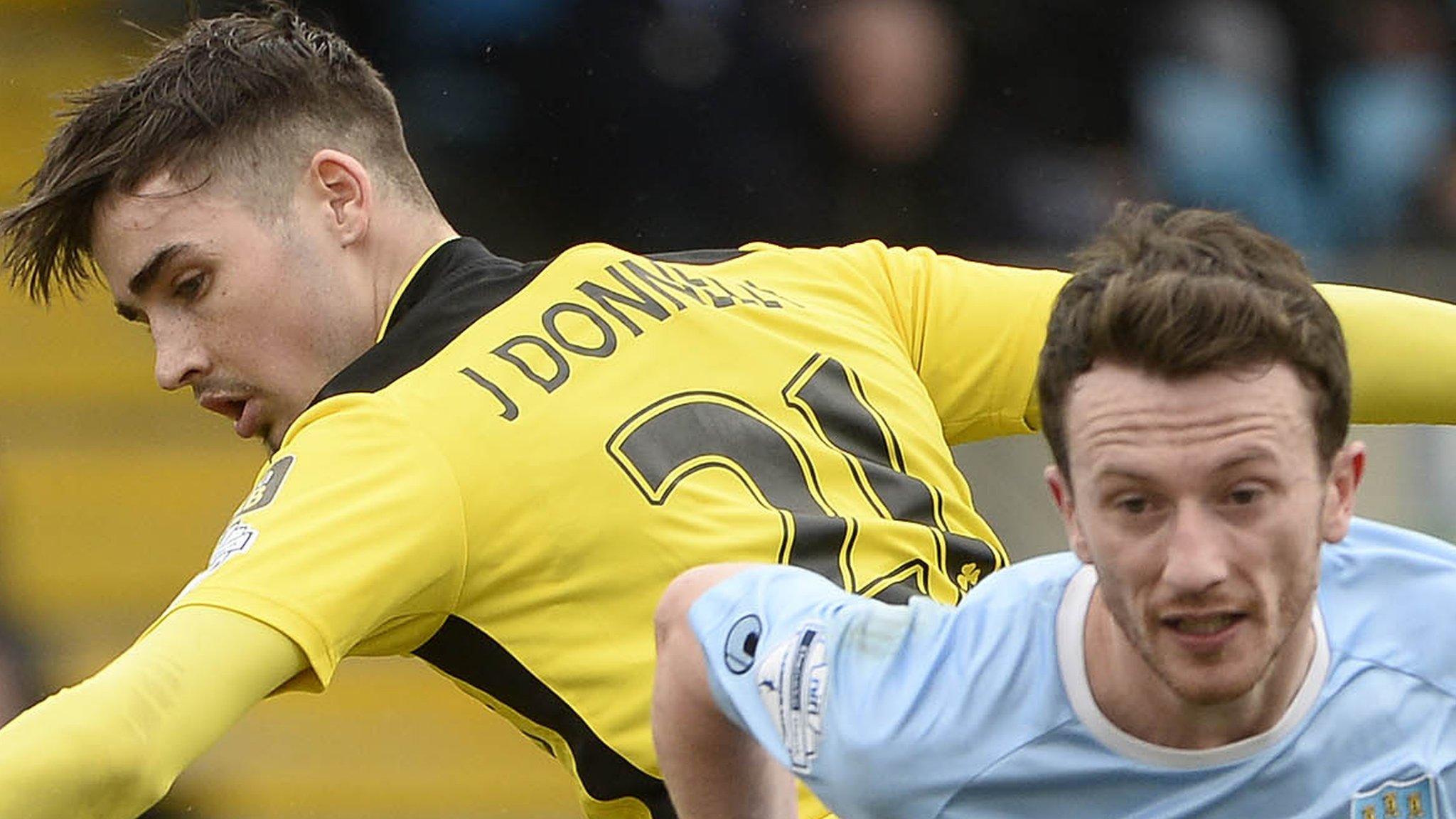 Cliftonville's Jay Donnelly in action against Willie Faulkner of Ballymena United