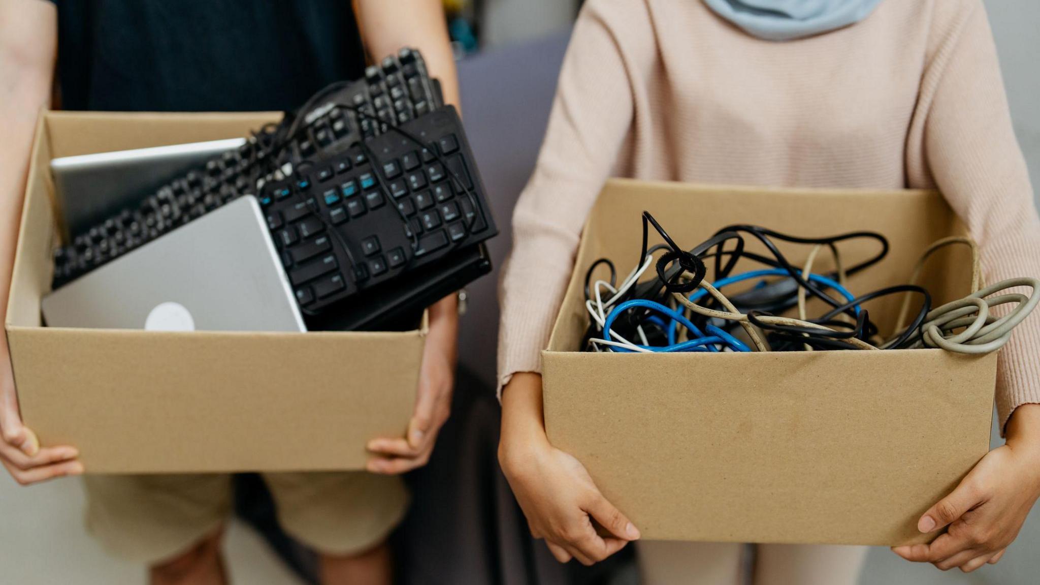 boy and girl holding boxes of electricals