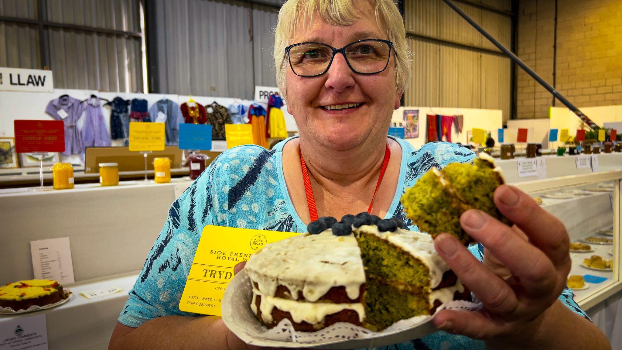 Woman holding an iced cake