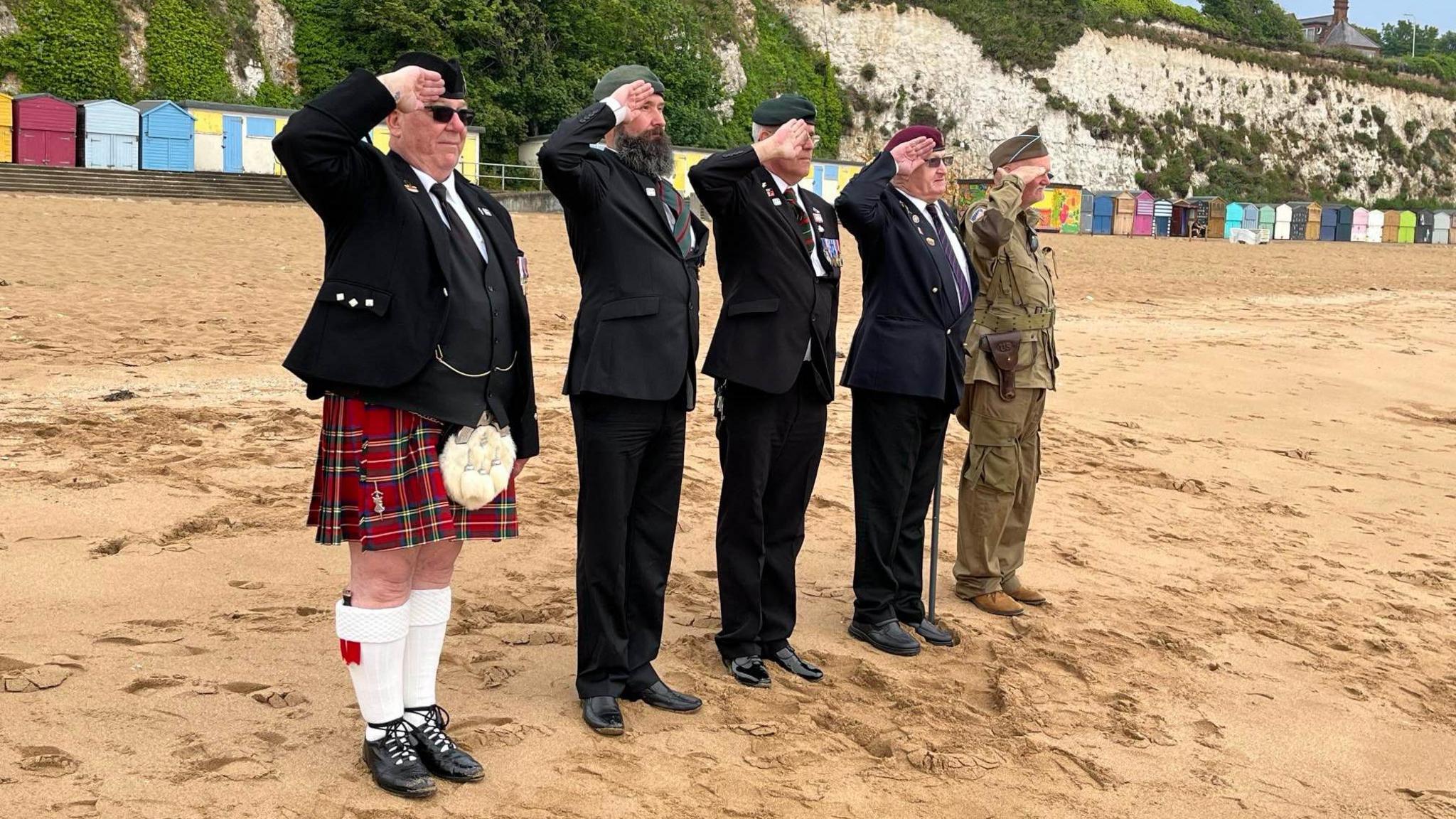 Veterans saluting on the beach at Broadstairs