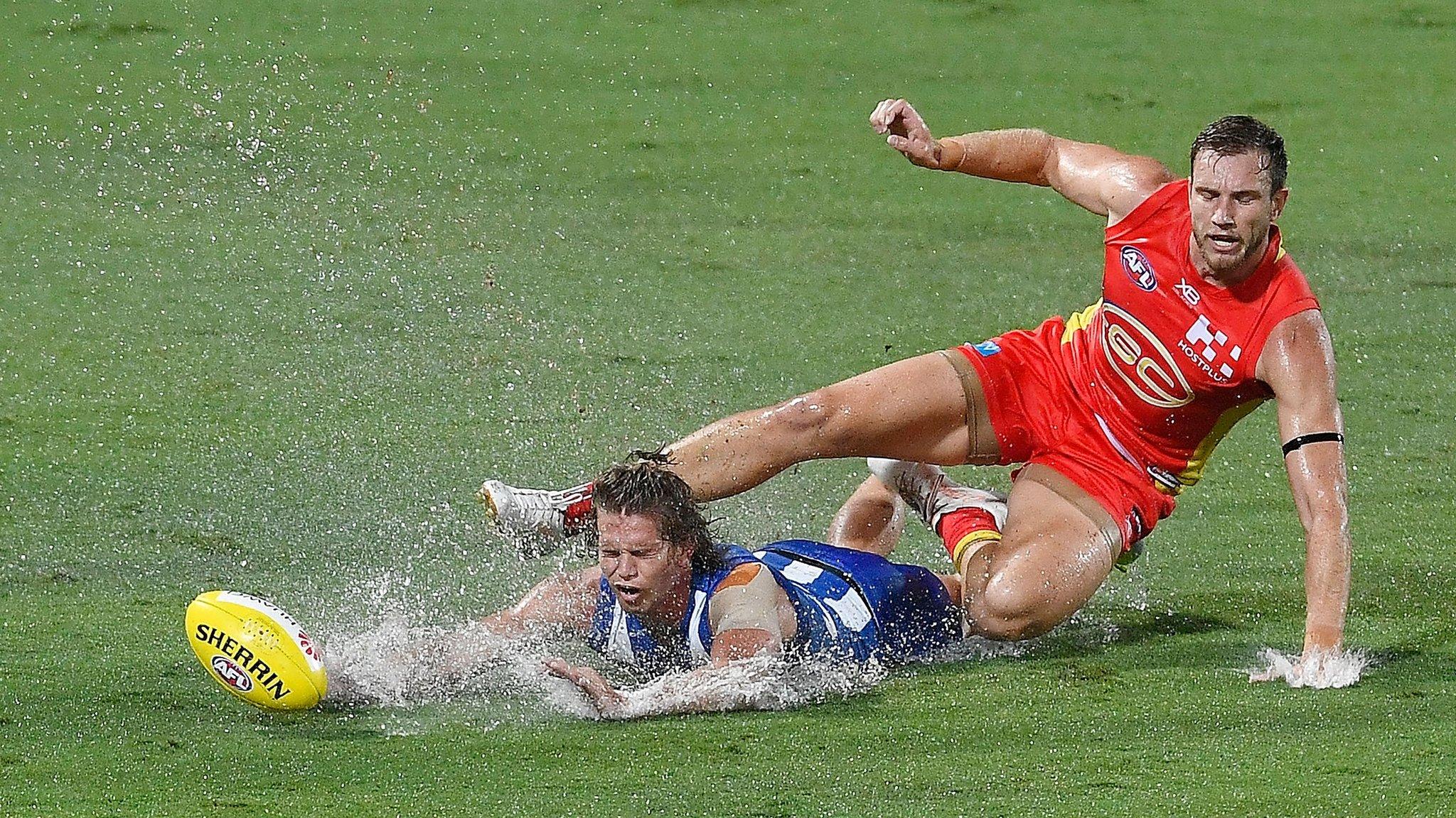 Jed Anderson of the Melbourne Kangaroos and Sam Day of the Gold Coast Suns