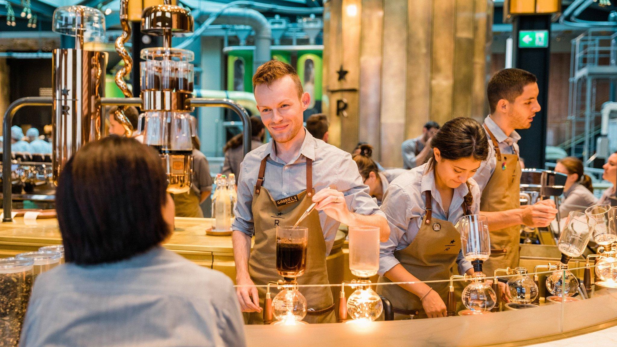 barista serving at bar, Starbucks Milan