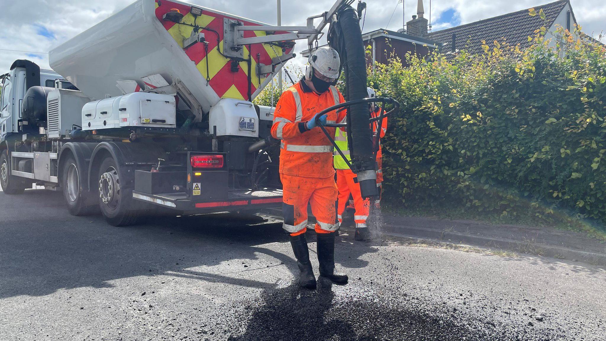 Truck with a hose on the back, which fires first air and then bitumen into a pothole.