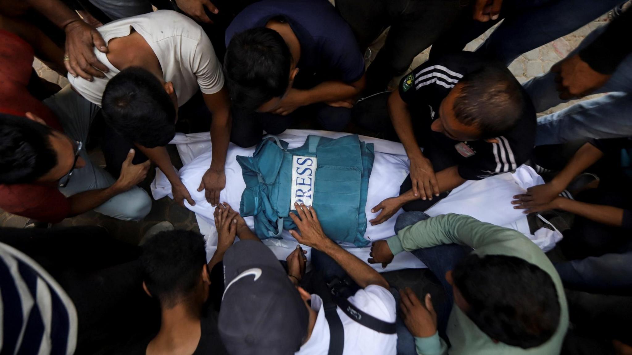 Mourners attend the funeral of a Palestinian journalist killed in an Israeli air strike, at al-Shifa hospital, in Gaza City (25 June 2025)