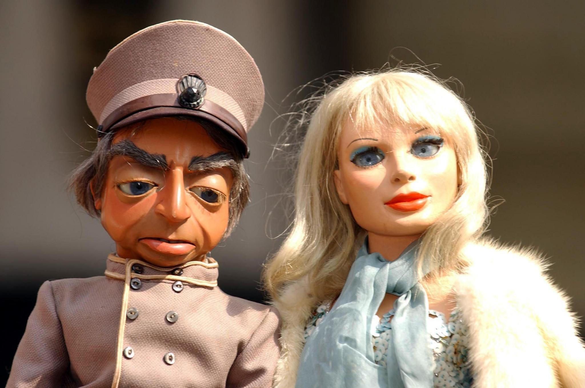 Parker and Lady Penelope in Thunderbirds - two puppets side by side, Parker in a chauffeur's uniform and Lady Penelope in blue sequins and fur