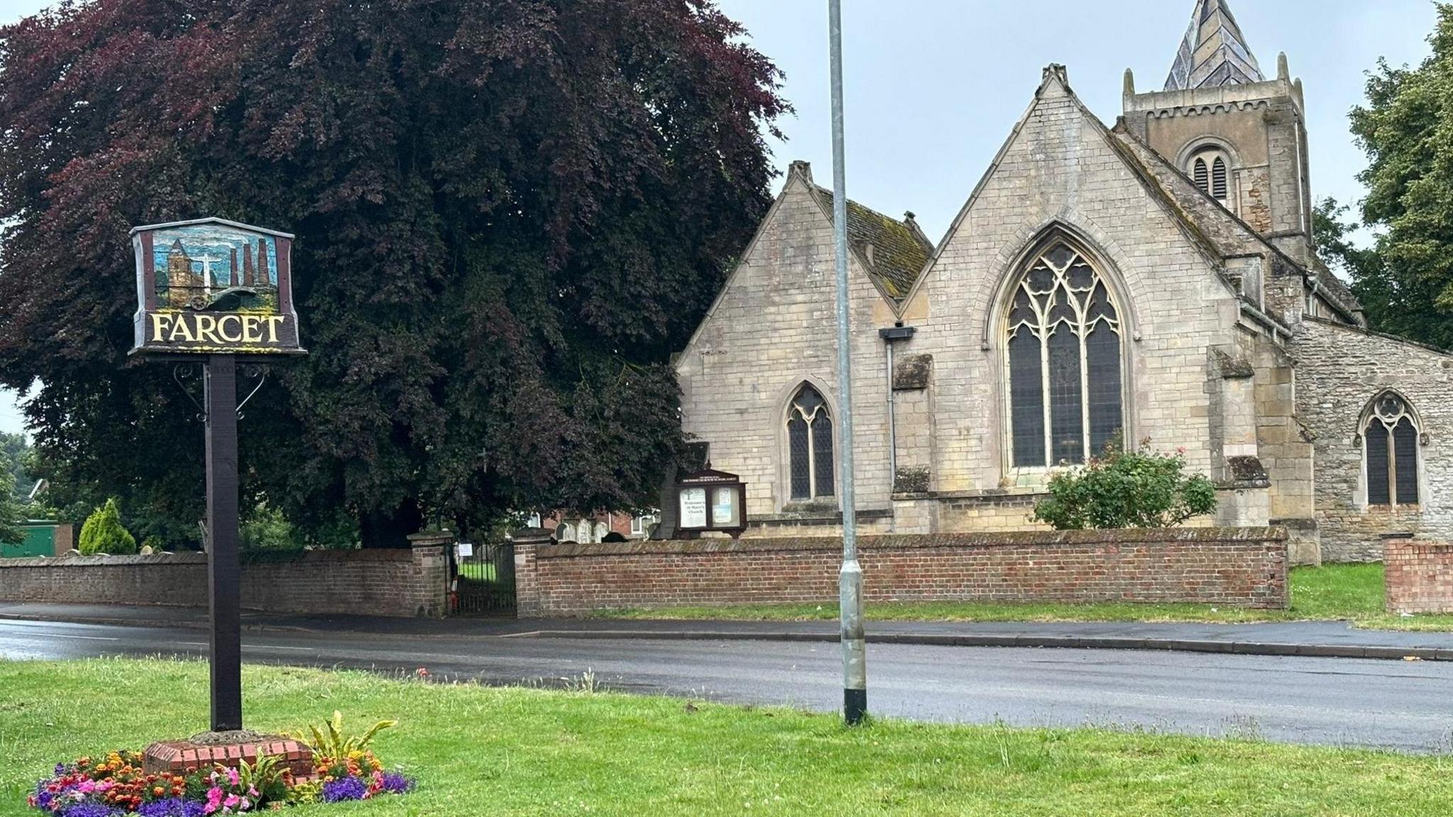 A church and village sign in Farcet