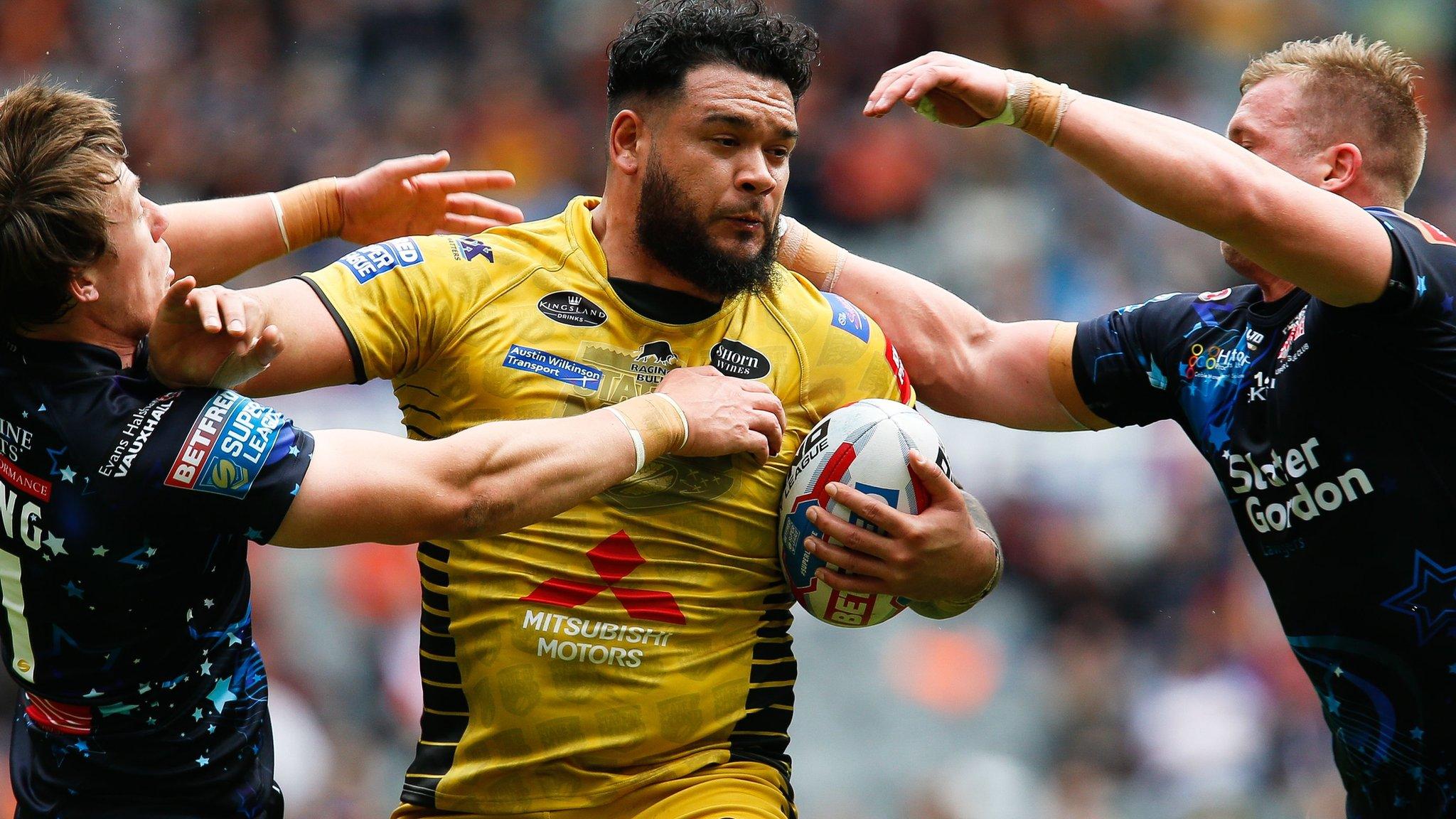 Salford's Ben Murdoch-Masila tries to break through two tacklers