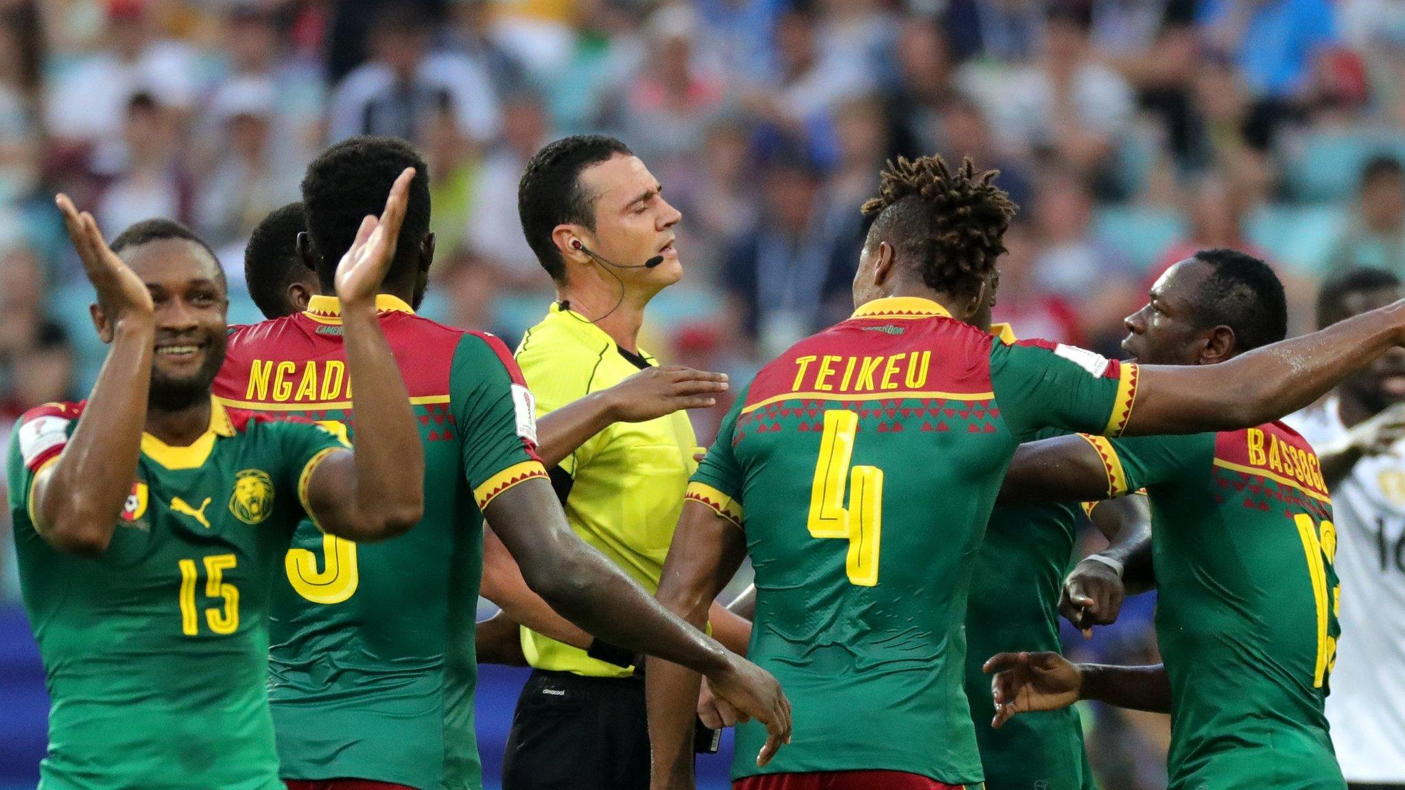 Cameroon players surround referee after VAR mistake