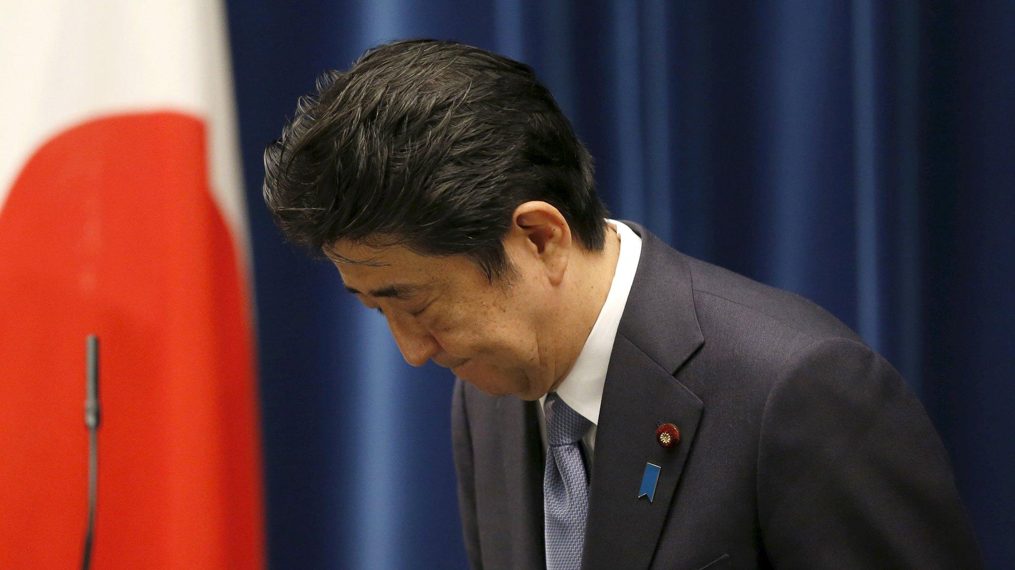 Japan's Prime Minister Shinzo Abe bows as he leaves a news conference after delivering a statement marking the 70th anniversary of World War Two's end, at his official residence in Tokyo, 14 August 2015