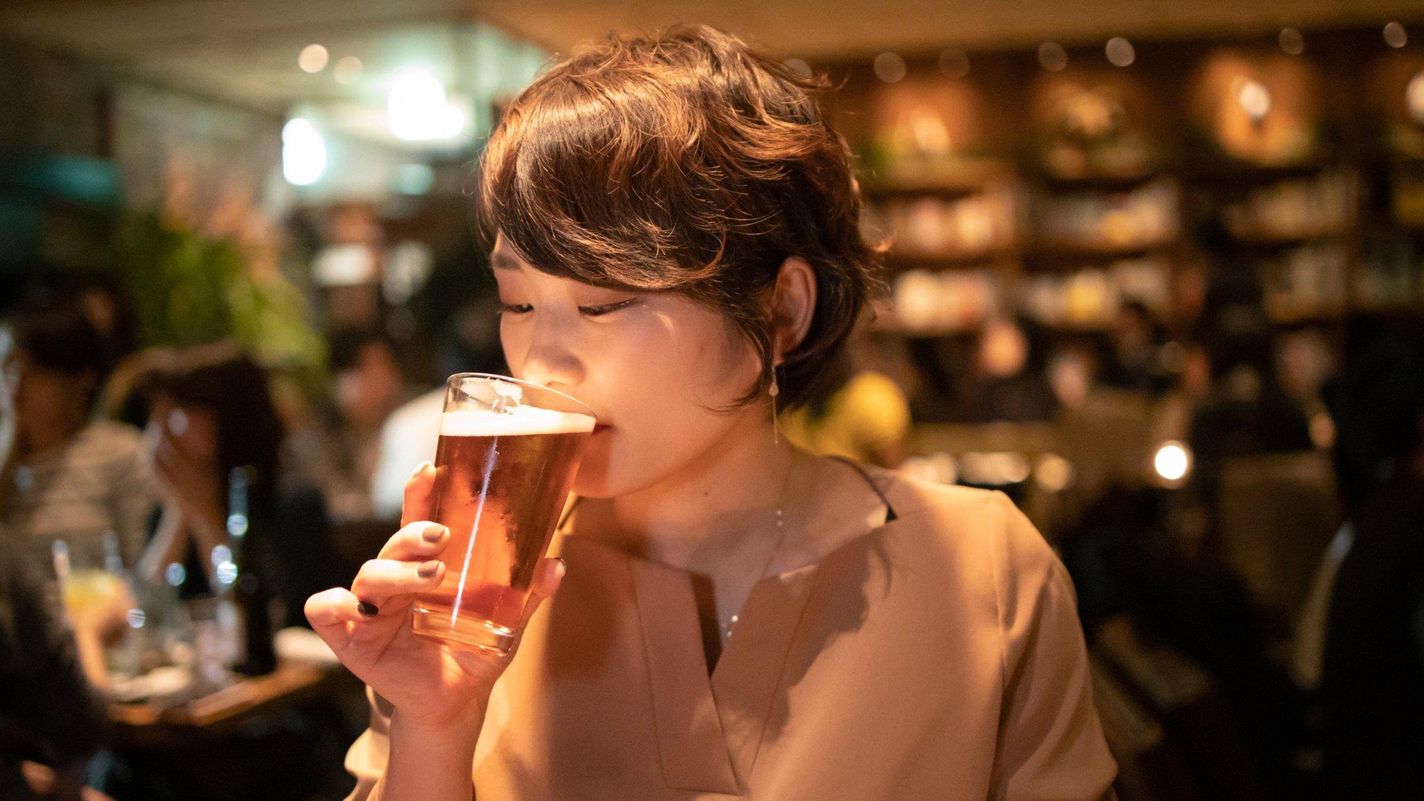 Young woman drinking beer