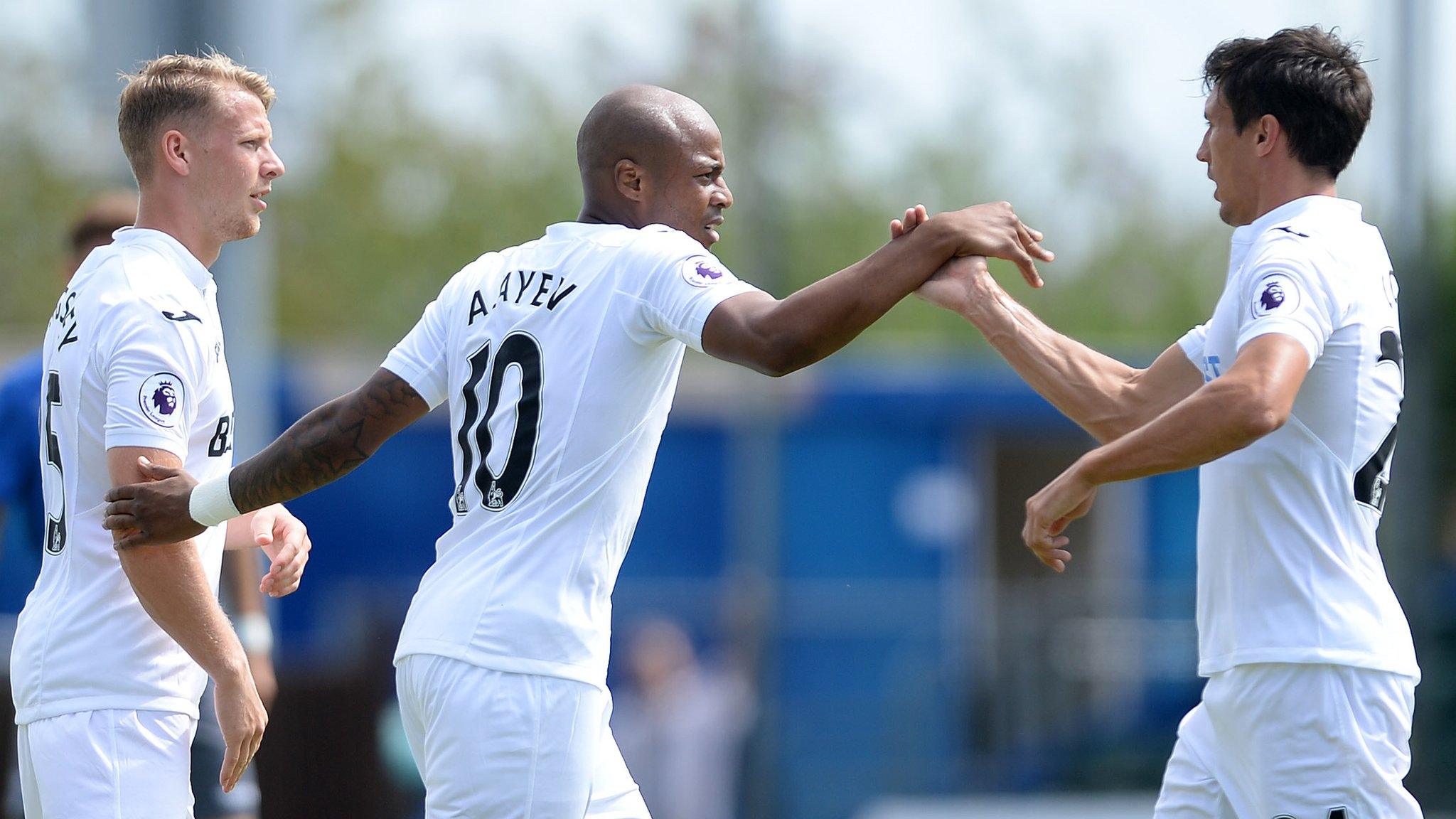 Andre Ayew celebrates with Stephen Kingsley and Jack Cork