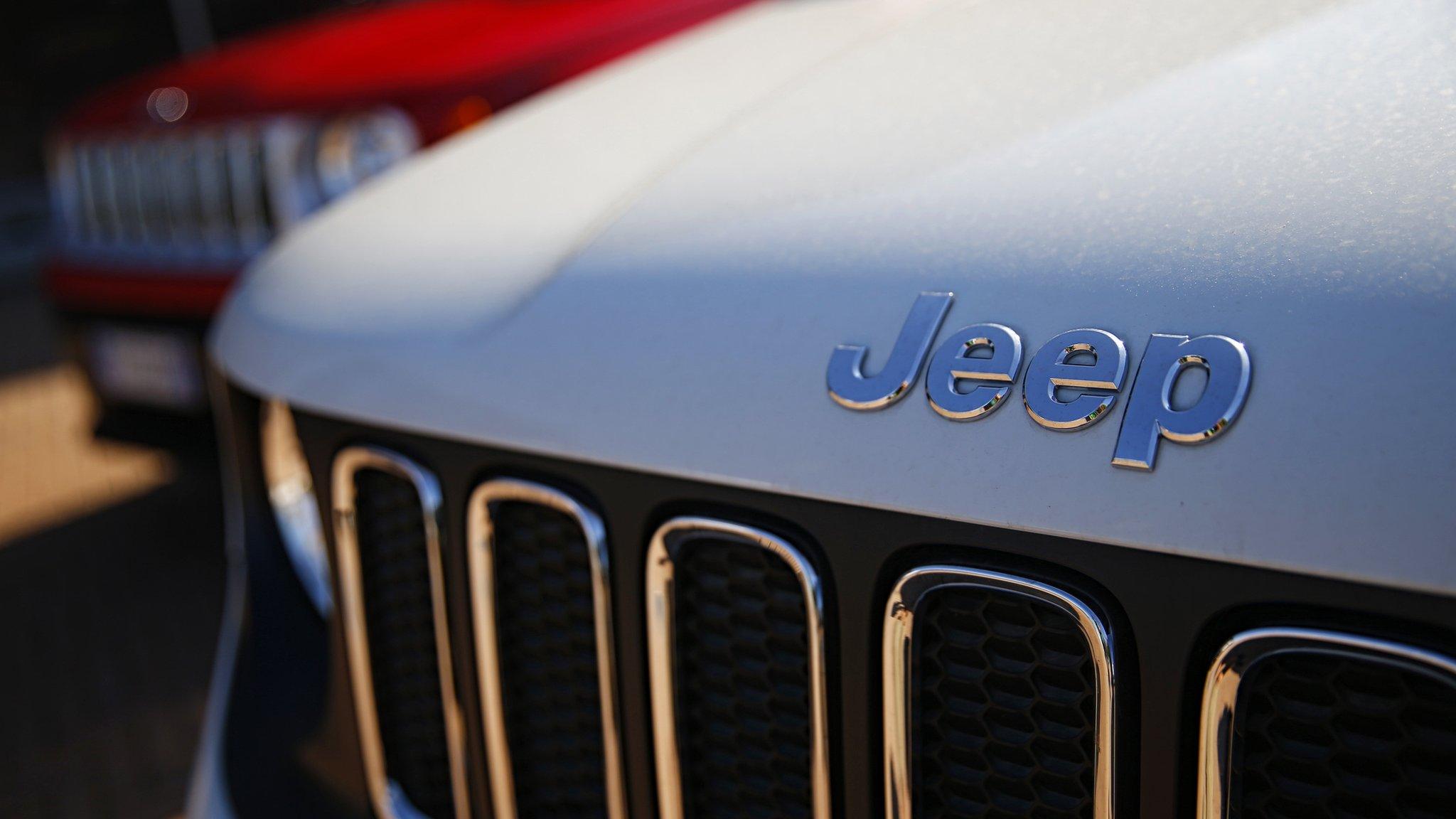 In this file photo taken on August 21, 2017 a car dealer in Turin shows the logos of Jeep, brands of Fiat Chrysler Automobiles (FCA).