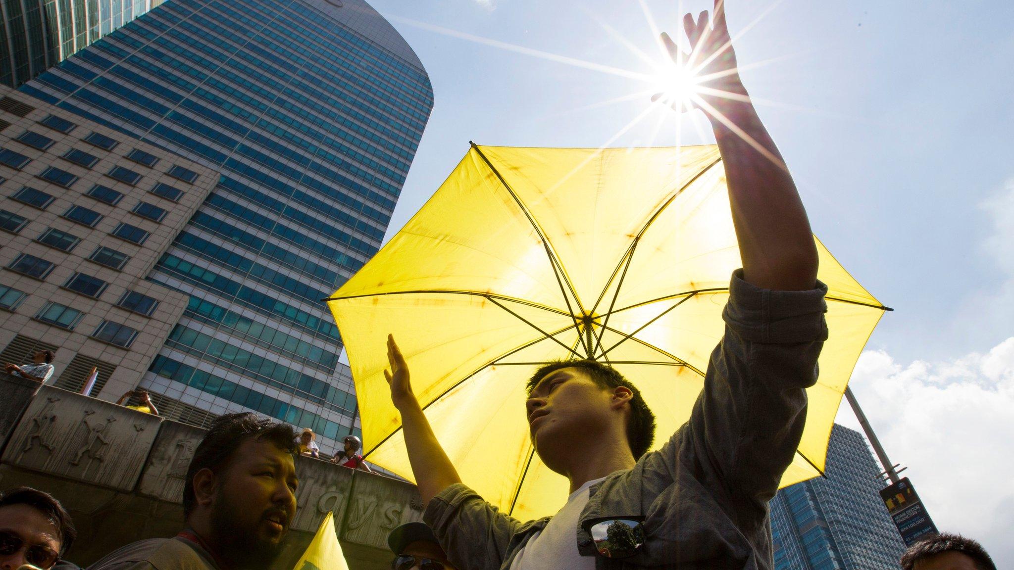 A man holds up his hands during the protest in Kuala Lumpur