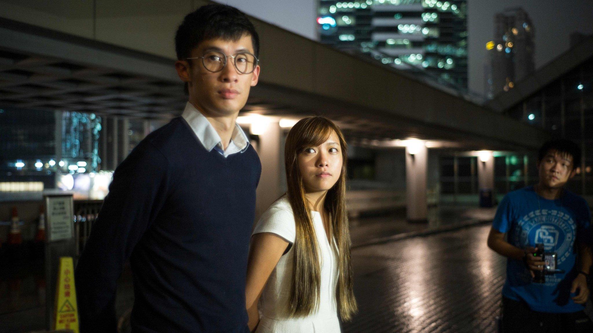 Newly-elected pro-independence lawmakers Baggio Leung (L) and Yau Wai-ching speak to the press outside the High Court in Hong Kong on October 18, 2016