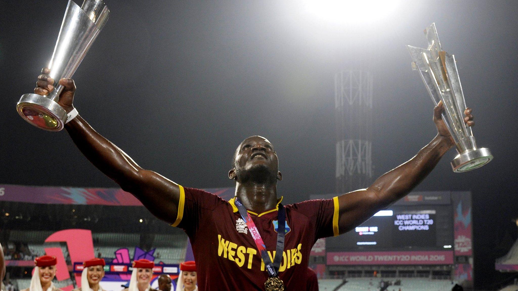 Darren Sammy celebrates with the World T20 trophies