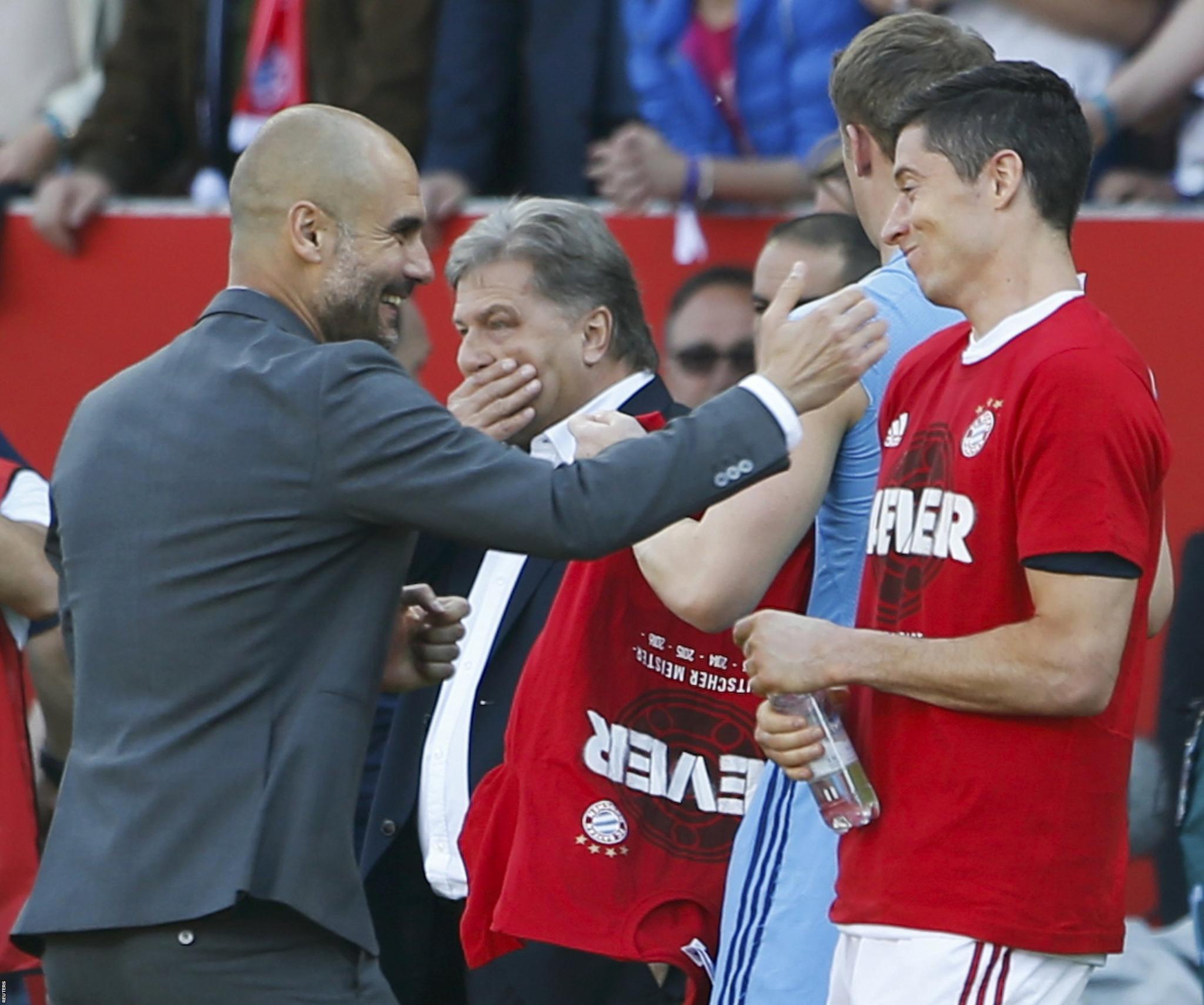 Bayern Munich boss Pep Guardiola celebrates with Robert Lewandowski after the final whistle