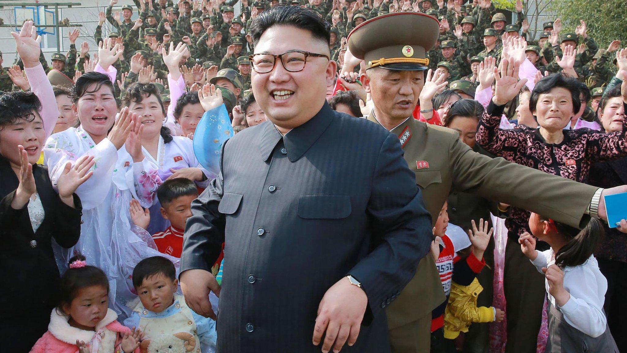 Kim Jong-un on May 5, smiling and standing in front of seemingly joyous citizens