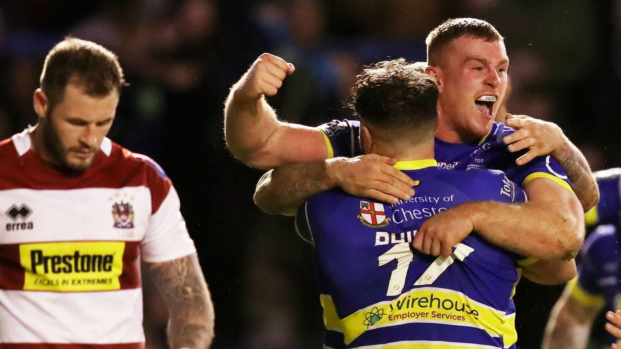 Jack Hughes of Warrington celebrates his try against Wigan