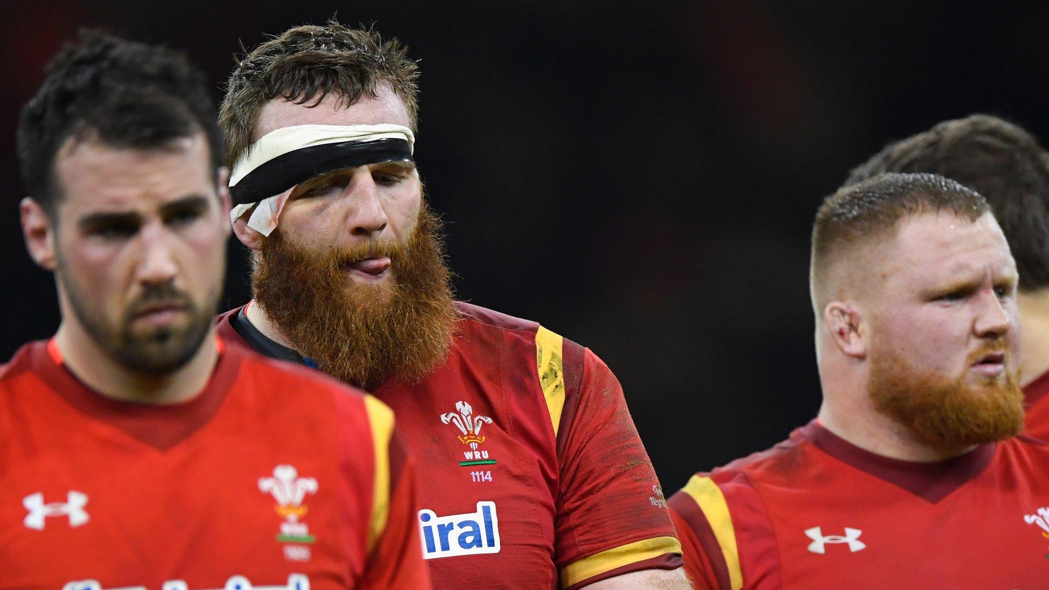 Wales forwards Scott Baldwin, Jake Ball and Samson Lee are dejected after defeat by England